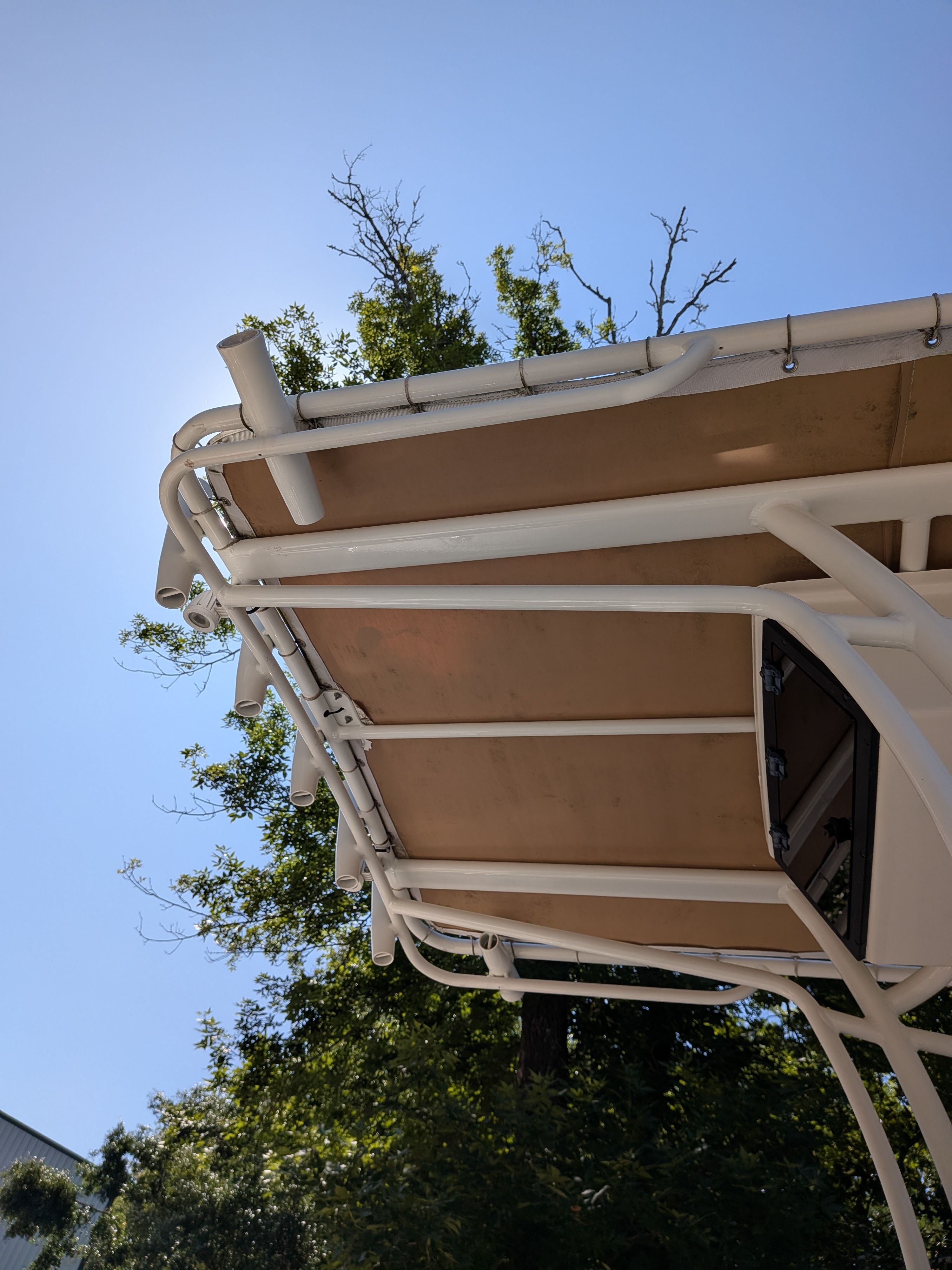 Pioneer 2020 202 Sportfish boat canopy against blue sky.