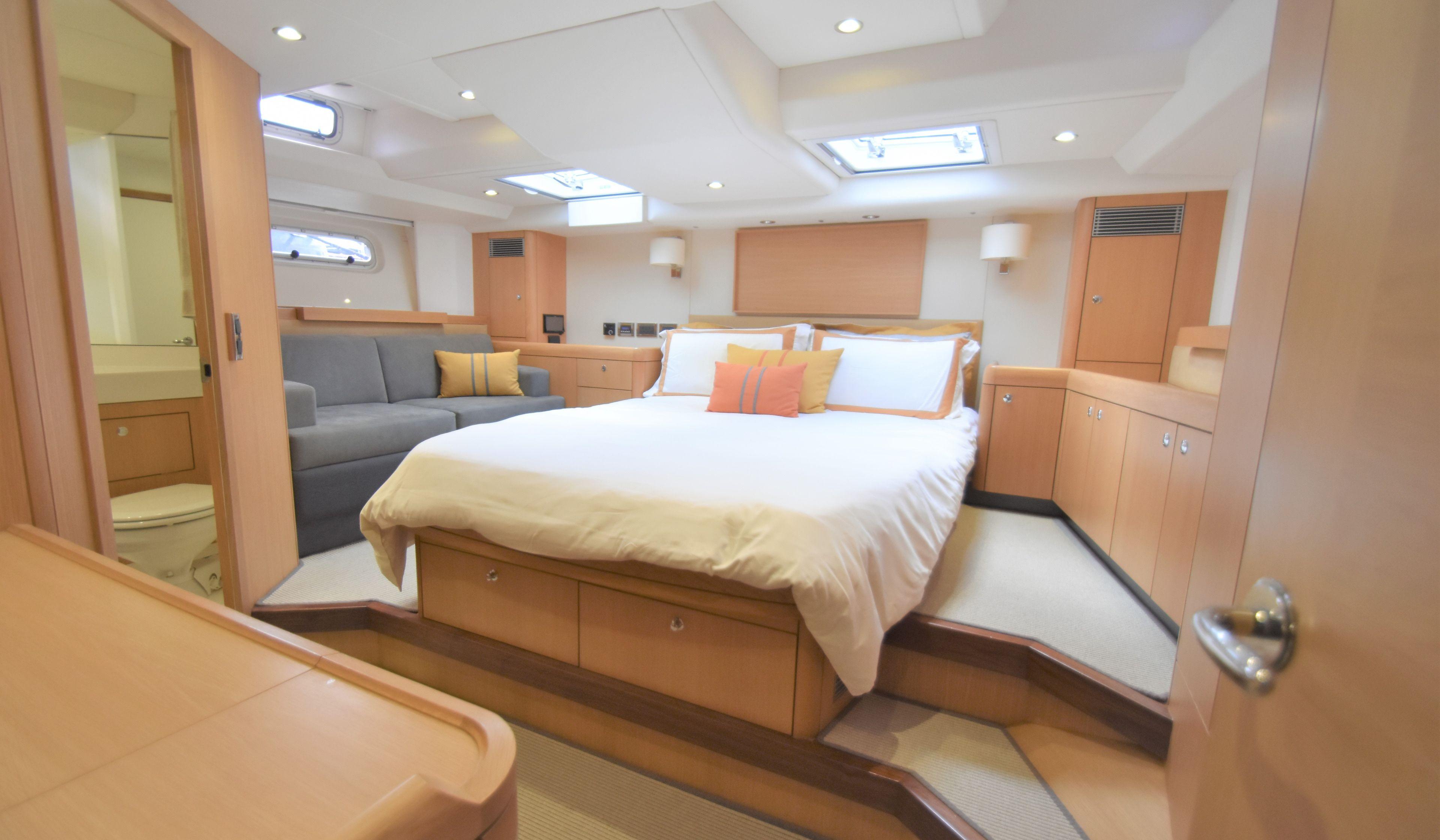 Luxurious bedroom interior of 2013 Oyster 625 yacht with modern furnishings and ample natural light.
