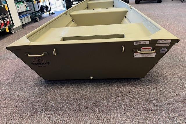 2026 Tracker Grizzly 14 Jon boat displayed indoors on carpeted floor.
