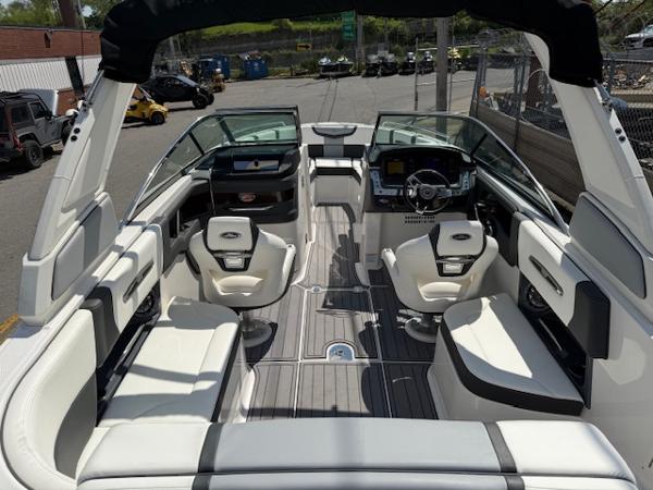2023 Chaparral 267 SSX boat interior with white seating and modern dashboard.