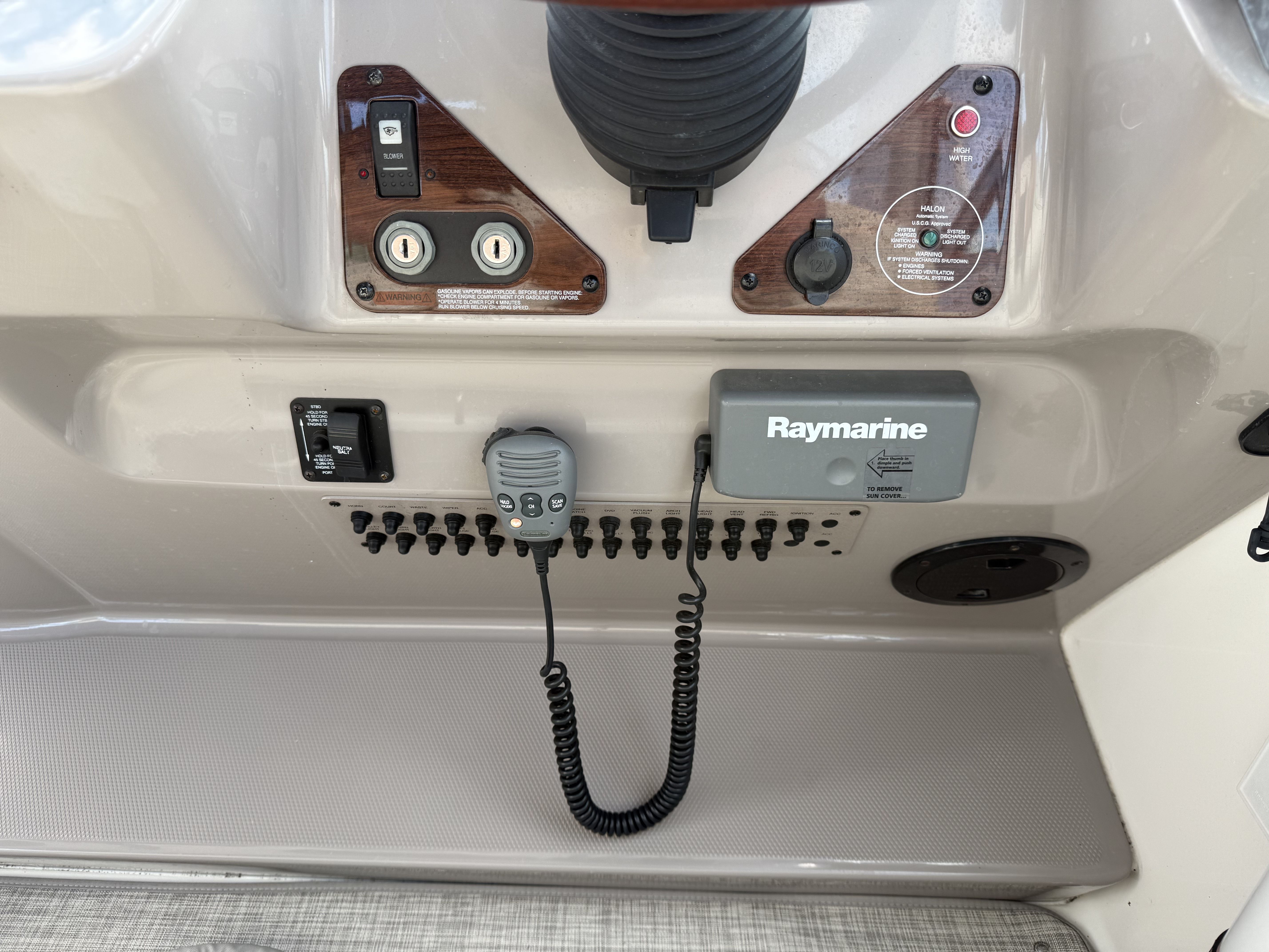 The image shows the dashboard of a 2008 Chaparral Signature 330 boat with various controls and a Raymarine device.