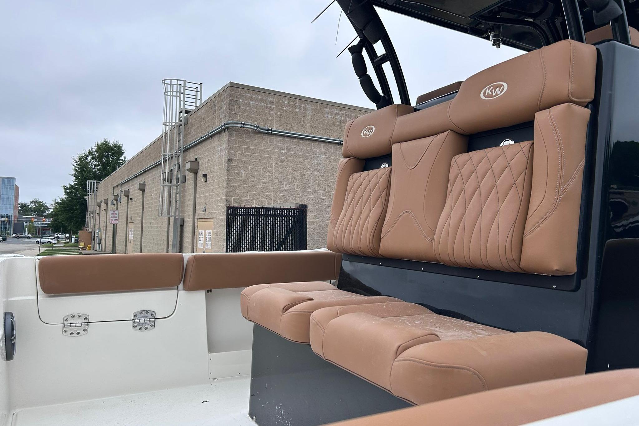 2026 Key West 291 FS boat with tan leather seating, docked near industrial building.