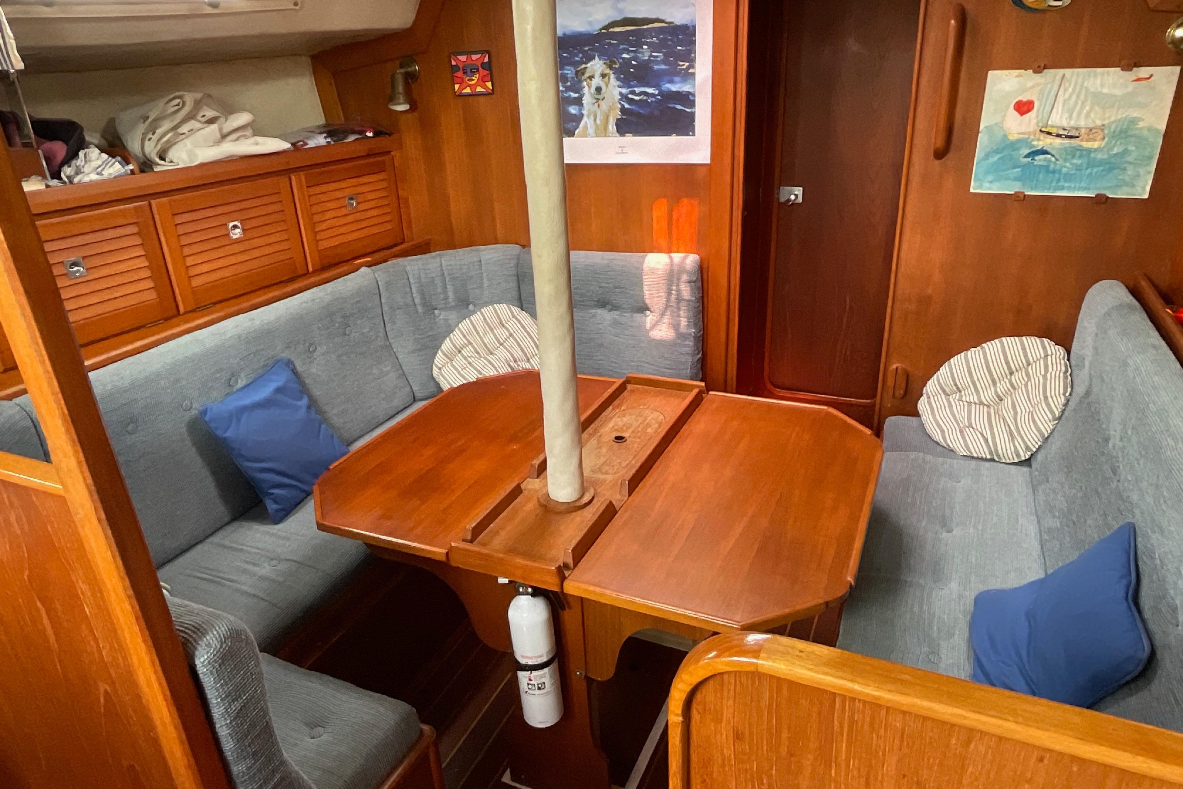 1988 Westerly Corsair 36 yacht interior with wooden dining table and cushioned seating.