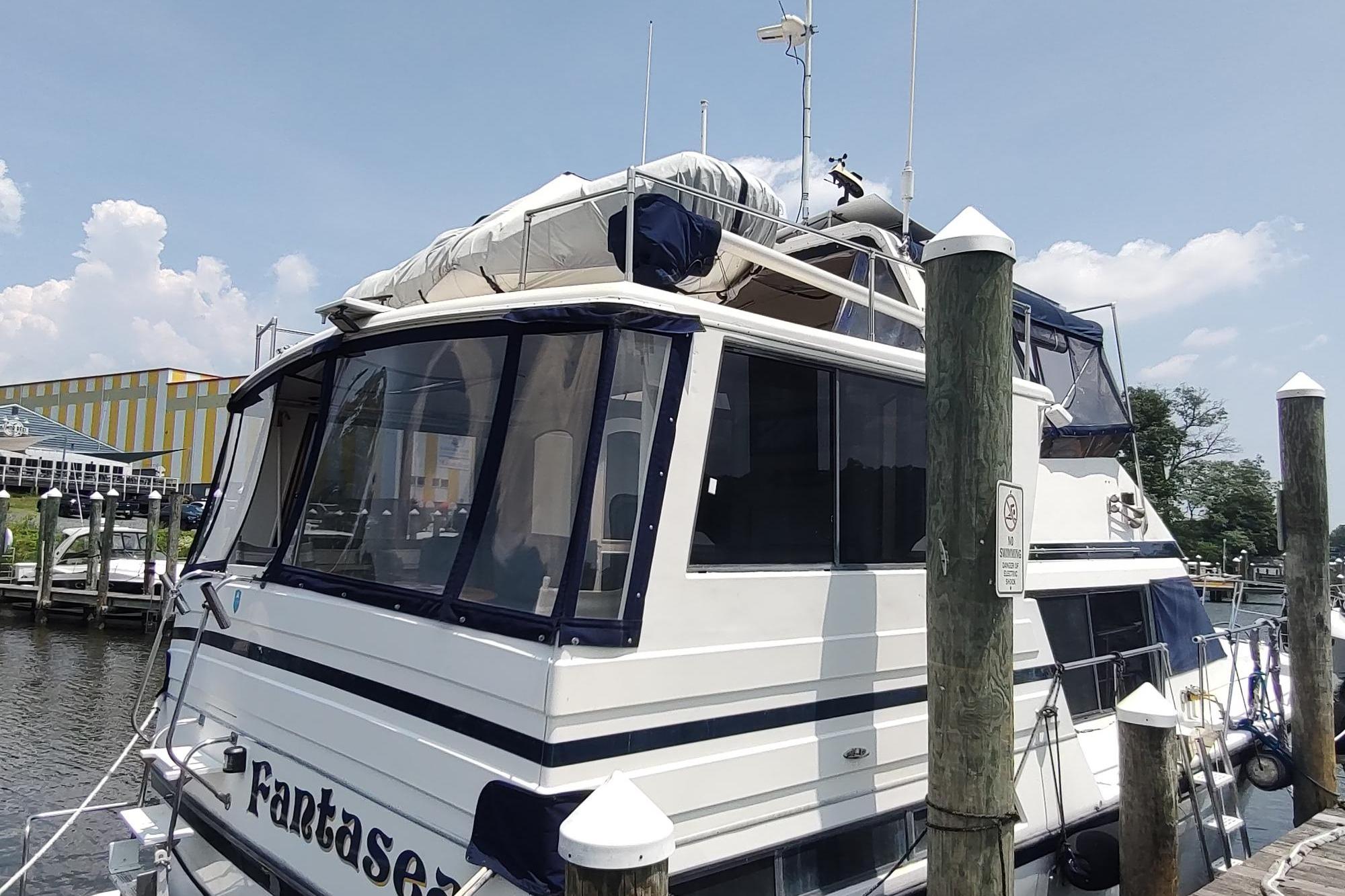 1989 Hyatt Double Cabin Motoryacht docked at marina, featuring spacious upper deck.