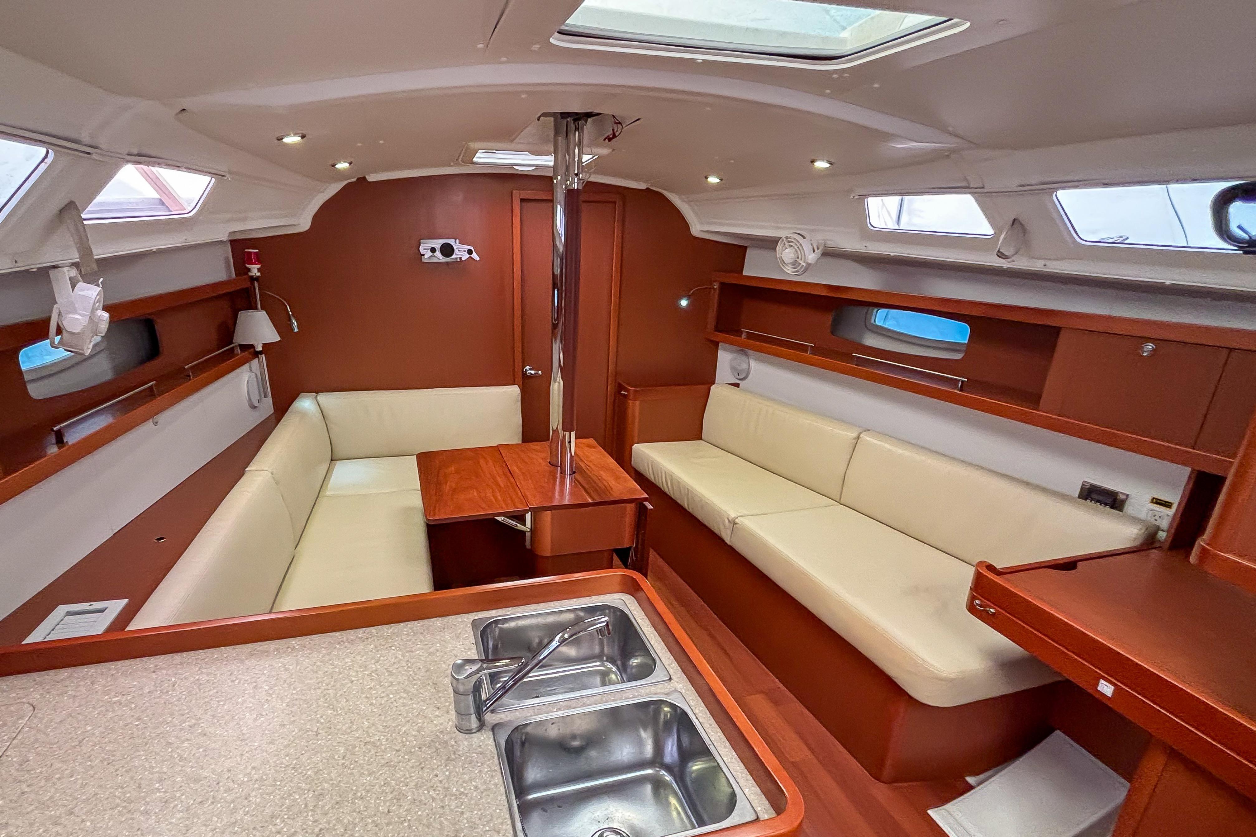 Interior of 2015 Beneteau Oceanis 37 sailboat with cozy seating and modern design.