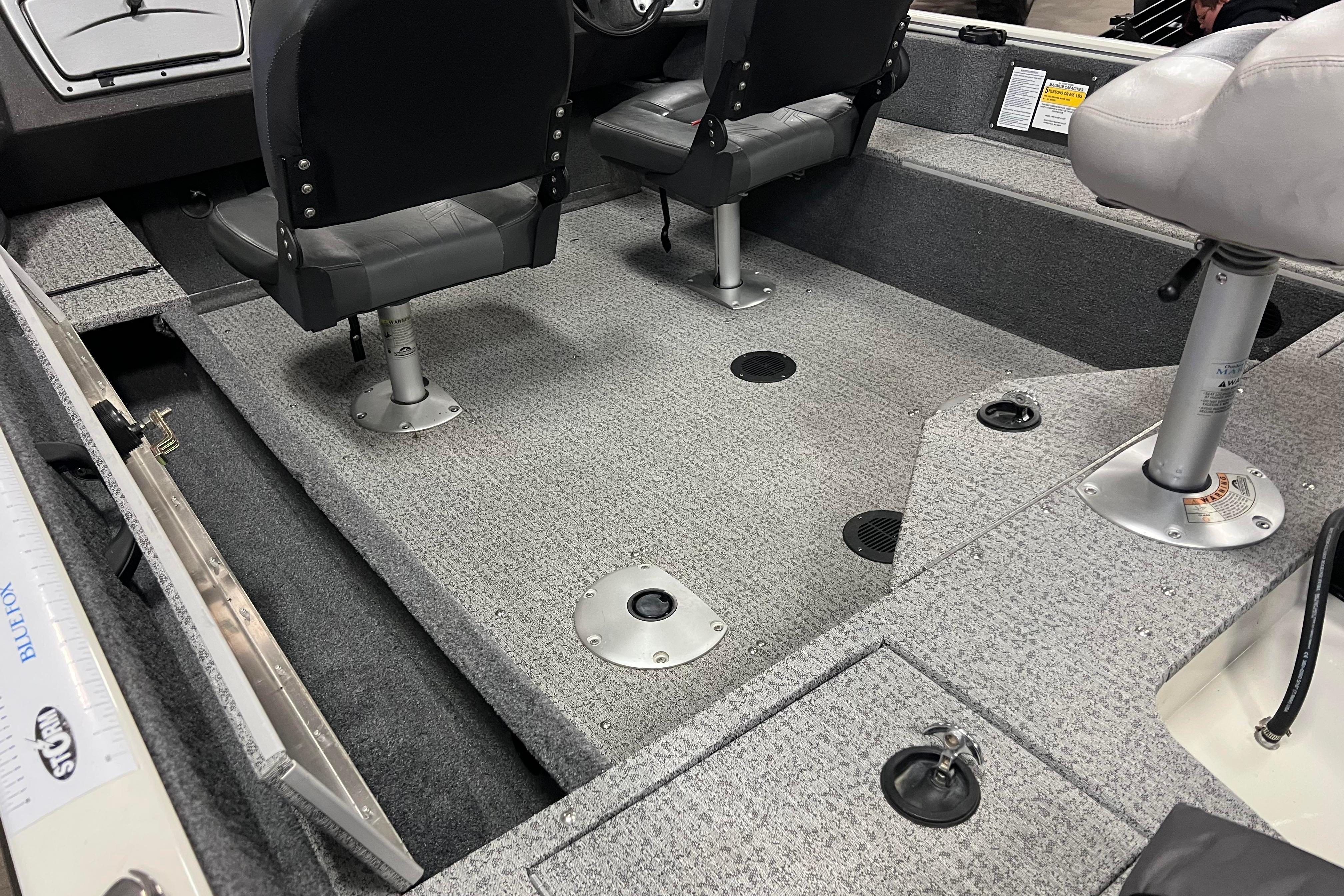 2022 Tracker Pro Guide V-16 WT boat interior with seating and carpeted flooring.