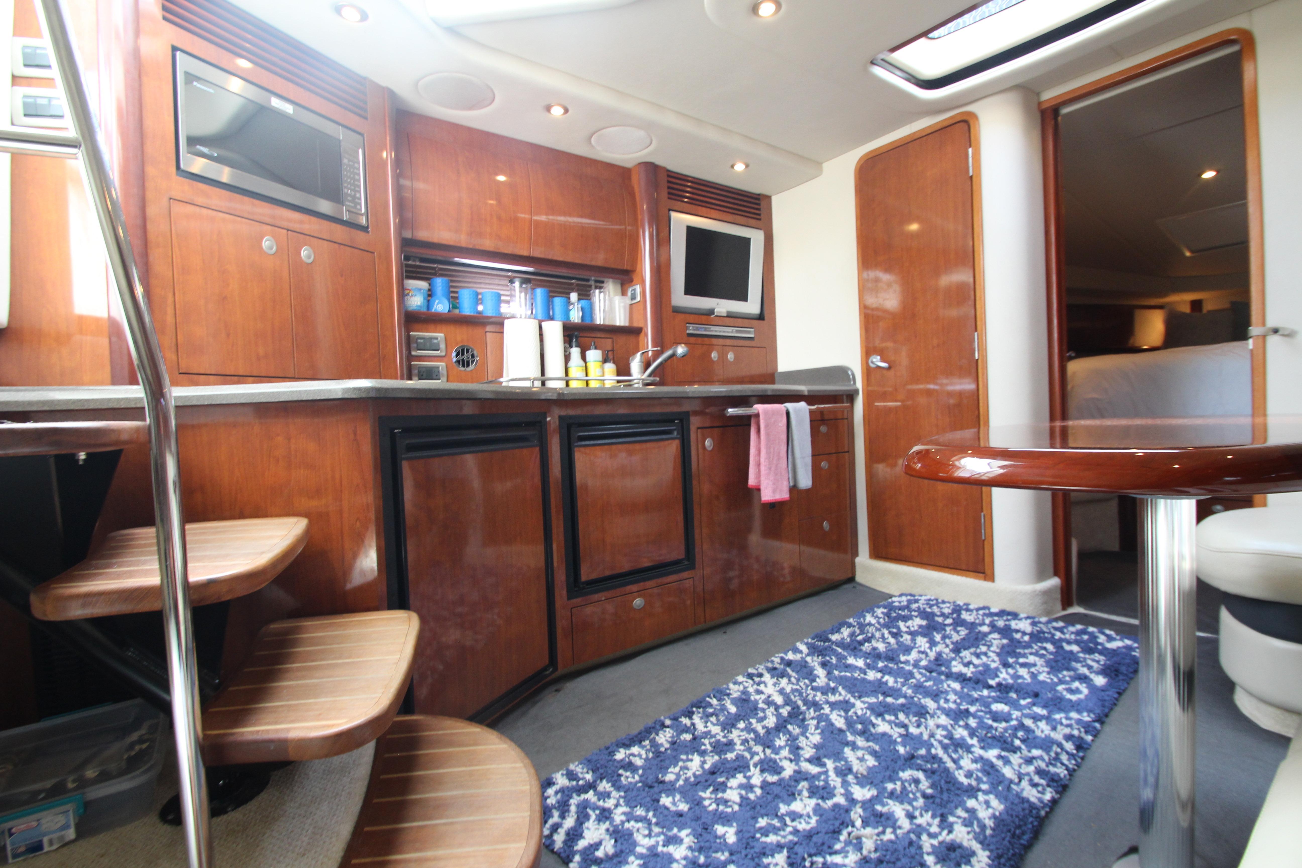 Interior of 2004 Sea Ray 40 Sundancer yacht with kitchen and seating area.