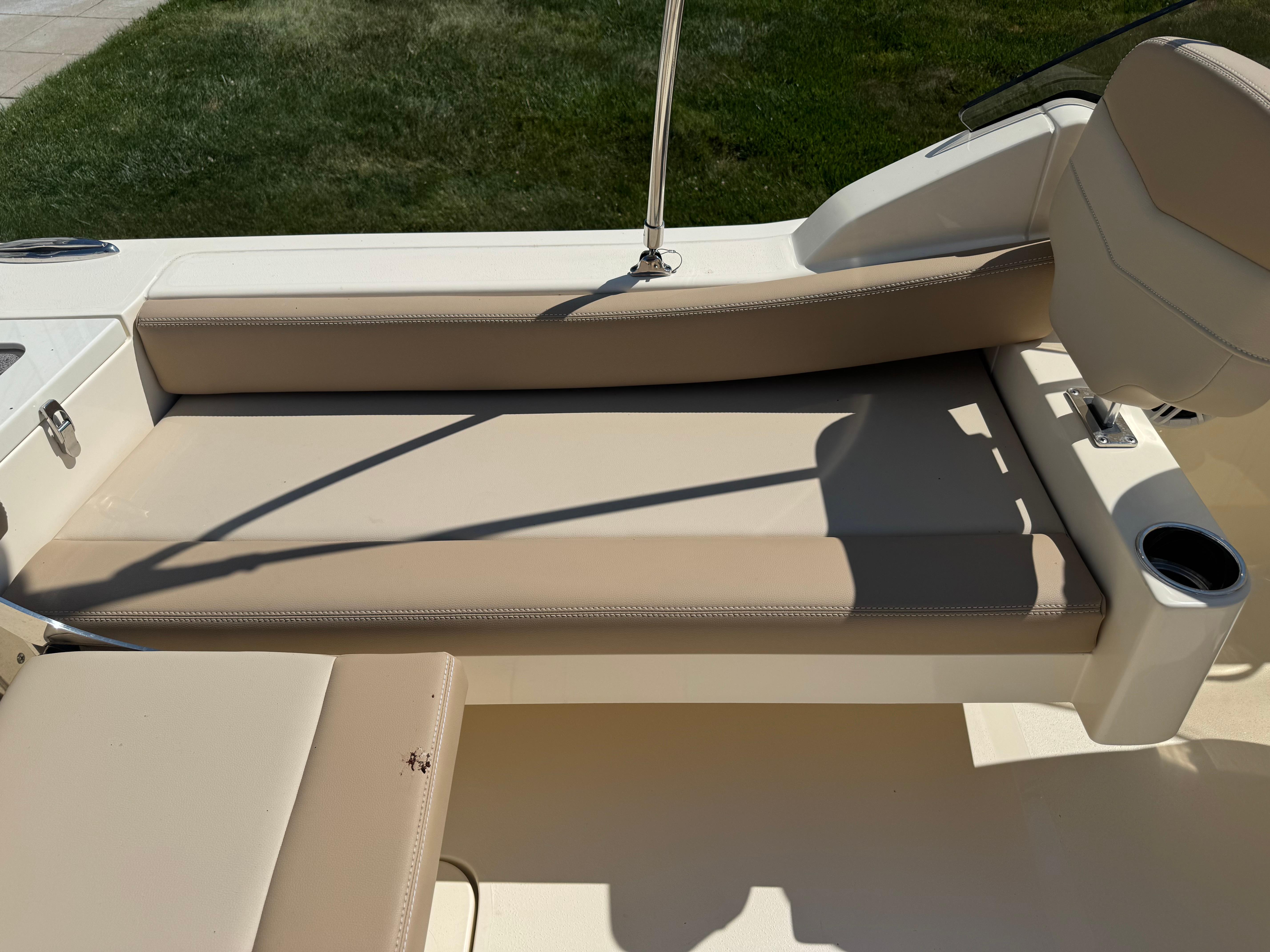 2025 Scout 215 Dorado boat interior with beige seating and cup holder.