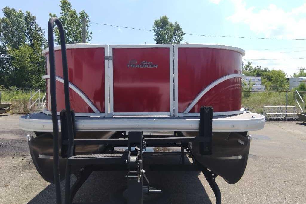 2026 Sun Tracker Party Barge 16 DLX pontoon boat, red exterior, parked outdoors.