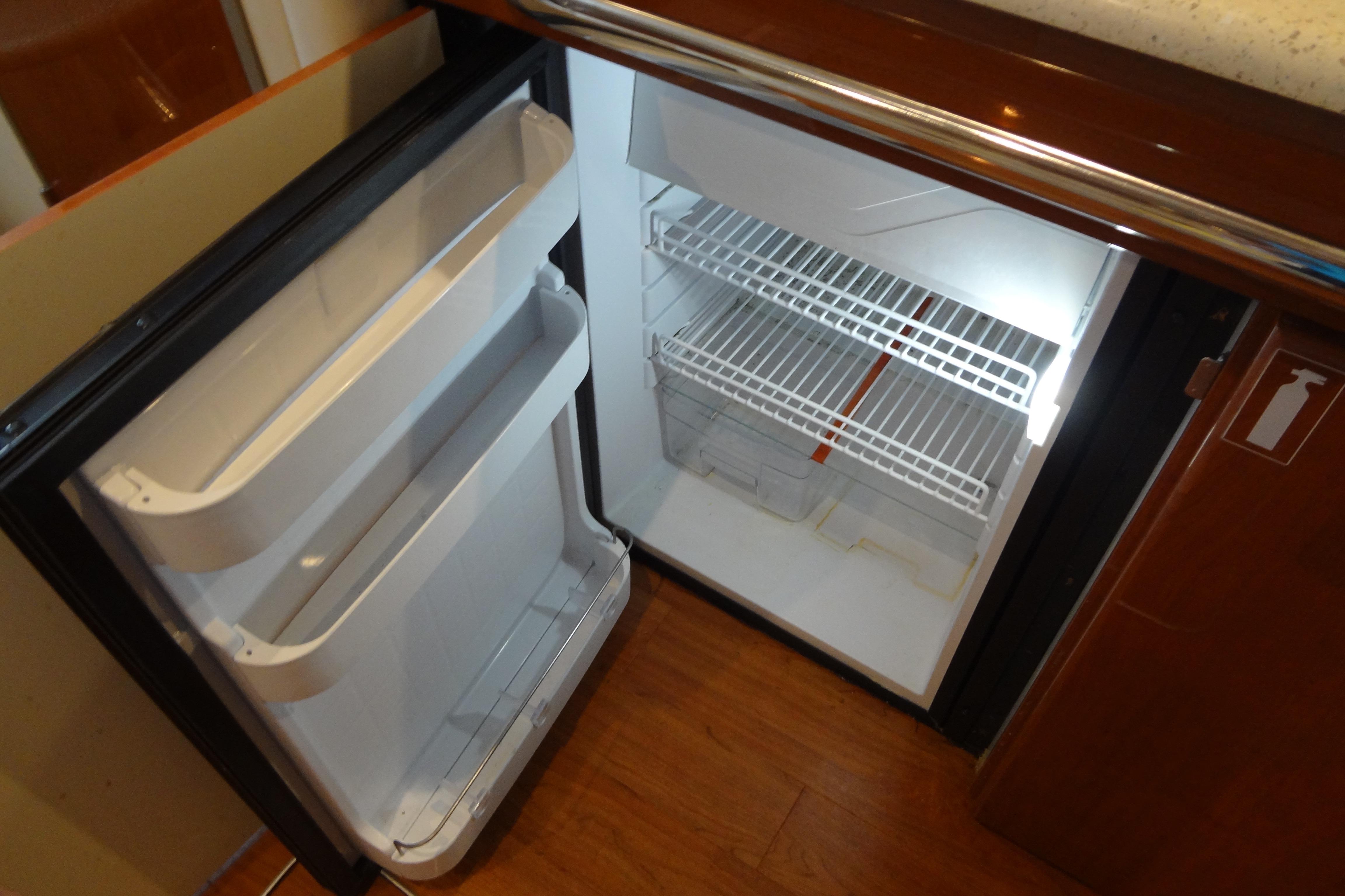 Open refrigerator inside 2007 Formula 34 Performance Cruiser, showcasing interior shelves and door compartments.