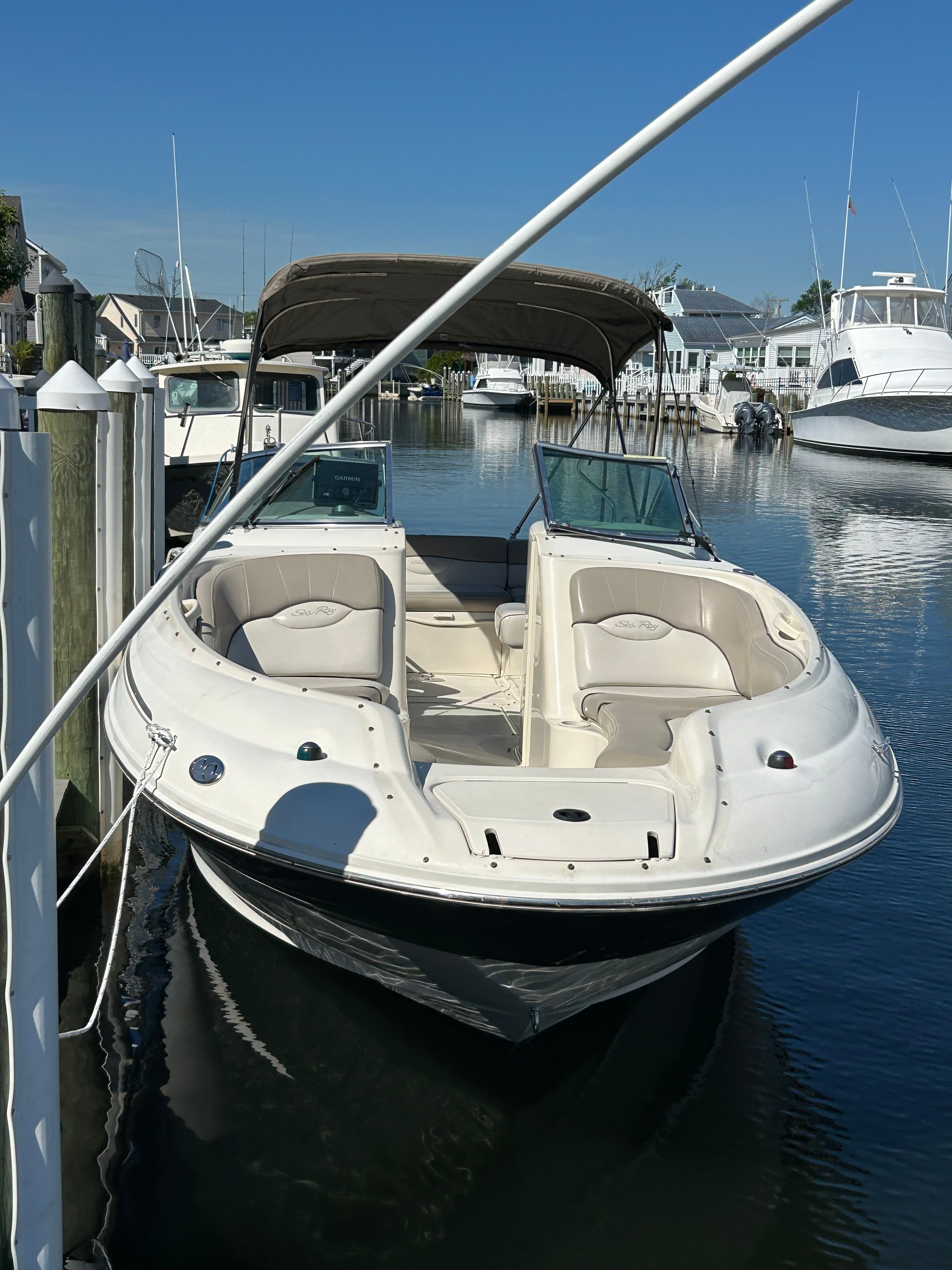 2003 Sea Ray 240 Sundeck boat docked in marina.