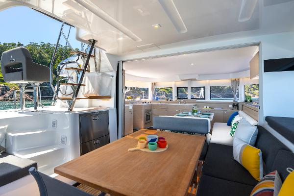 Luxurious interior of 2025 Lagoon 43 yacht with modern dining and seating area.