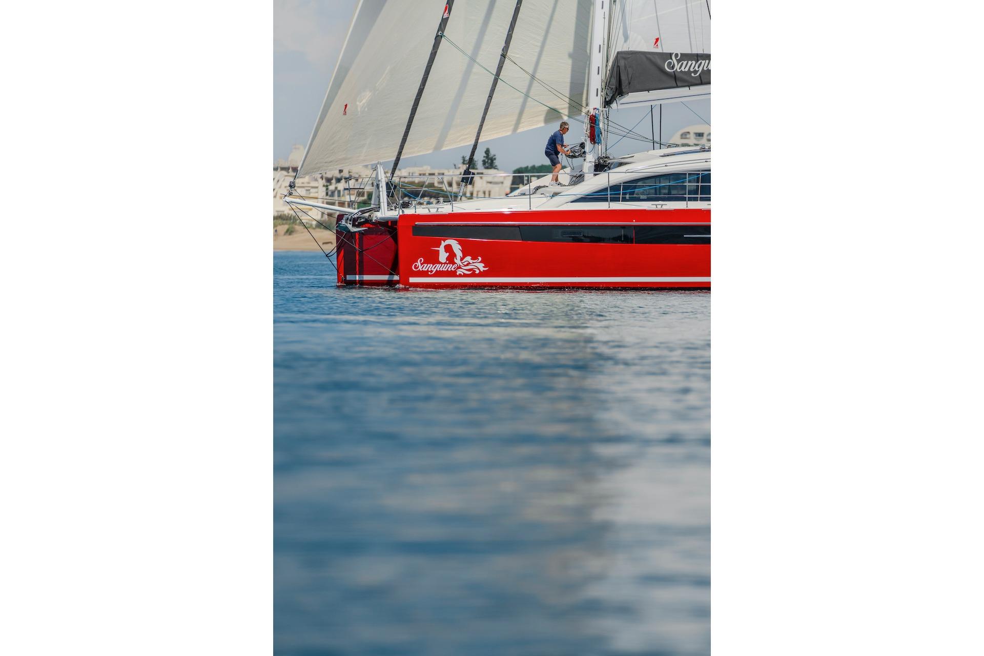 Red Privilege Signature 510 yacht sailing on calm waters, 2025 model.