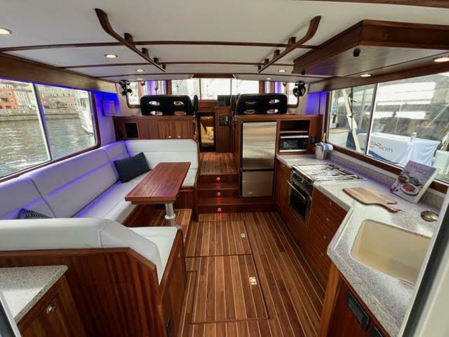 Luxurious interior of 2024 Nordic Tug 40 with modern kitchen and seating area.