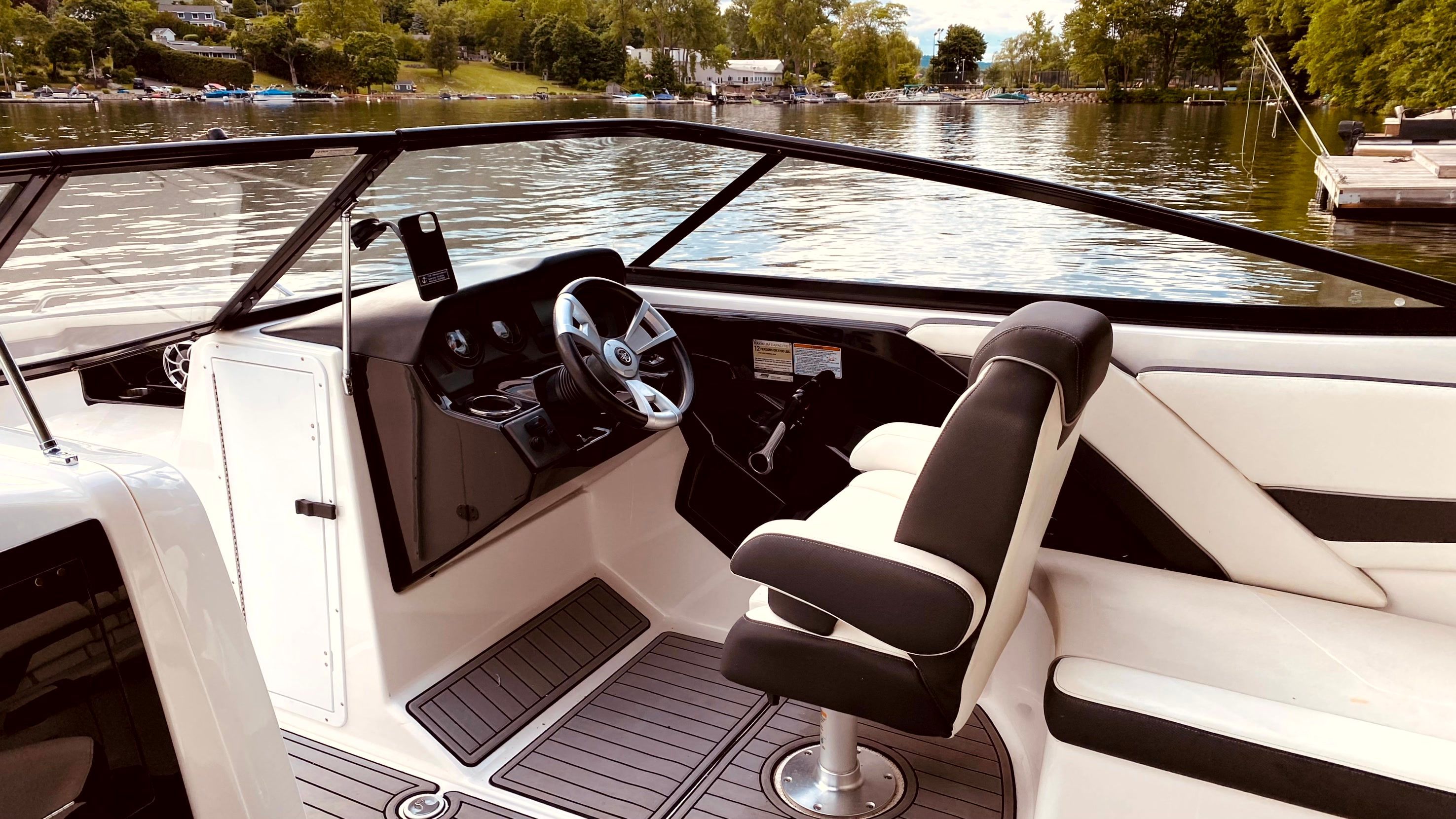 Interior of a 2016 Yamaha AR240 boat on a serene lake.