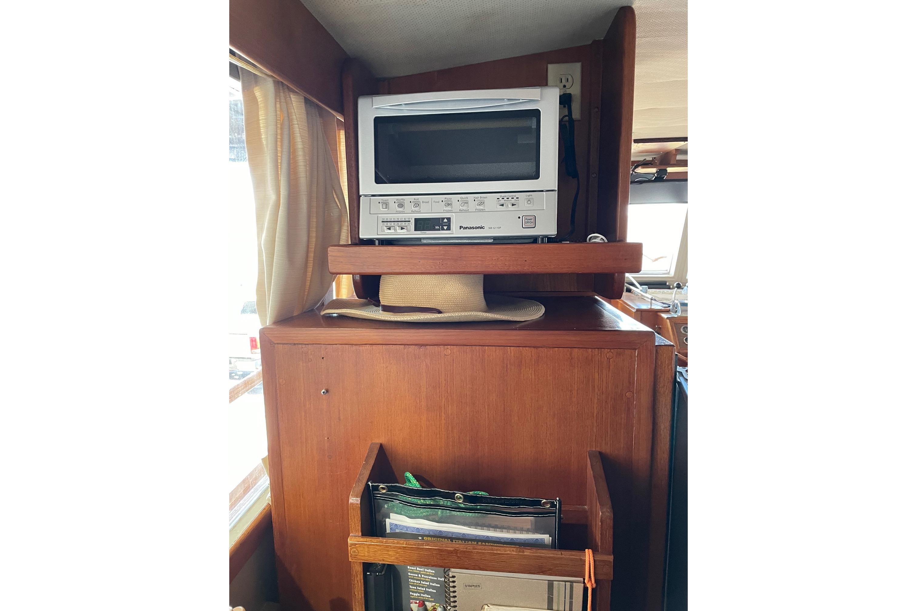 1978 Grand Banks GB36570 interior with vintage TV and wooden cabinetry.
