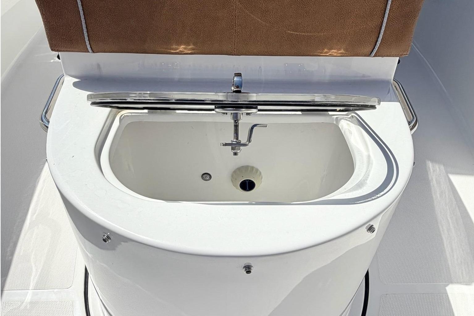 Sea Hunt Ultra 305 Coffin Box 2026 with open storage compartment.