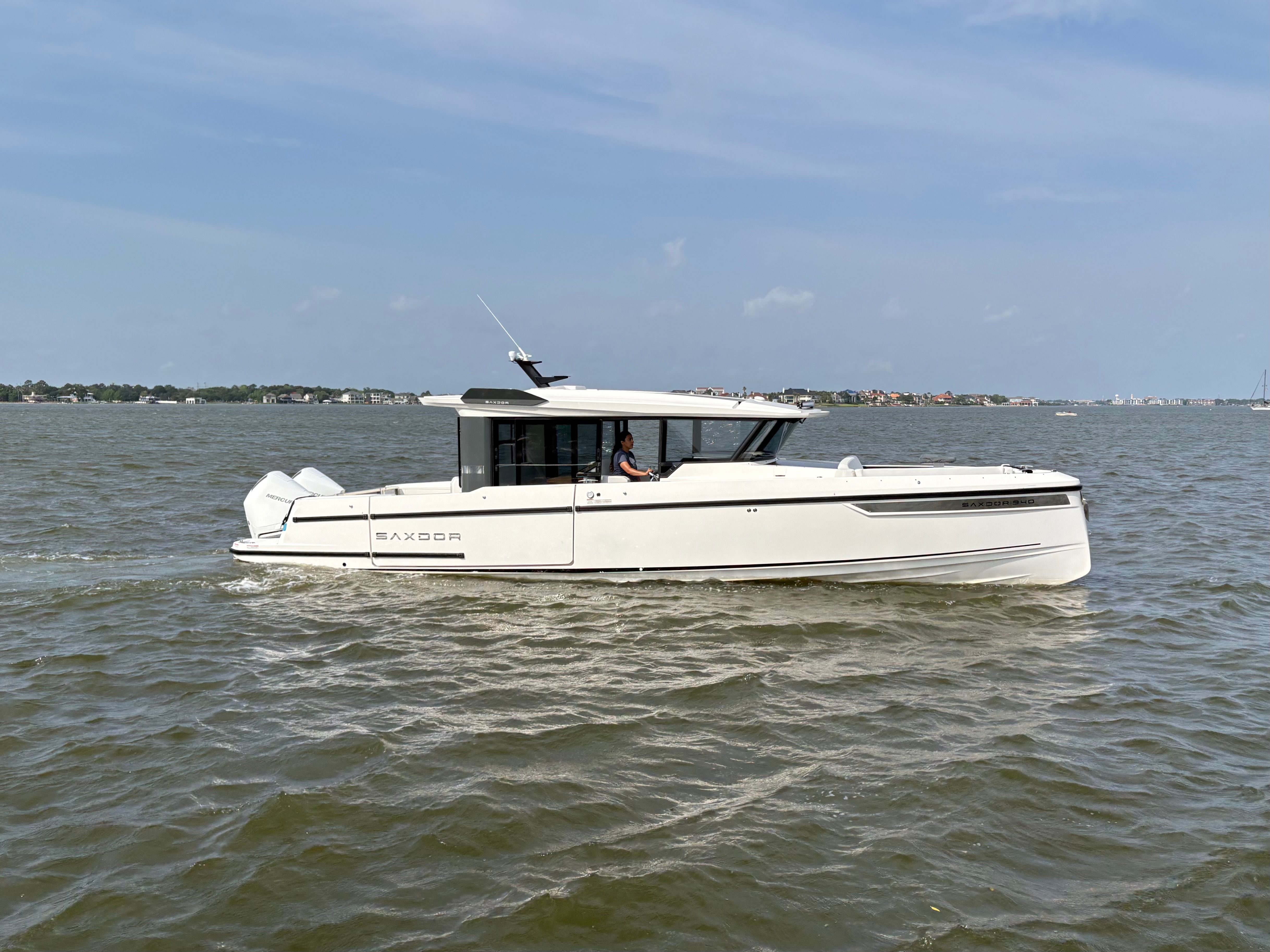 Saxdor 340 GTWA 2026 cruising on calm waters under sunny skies.