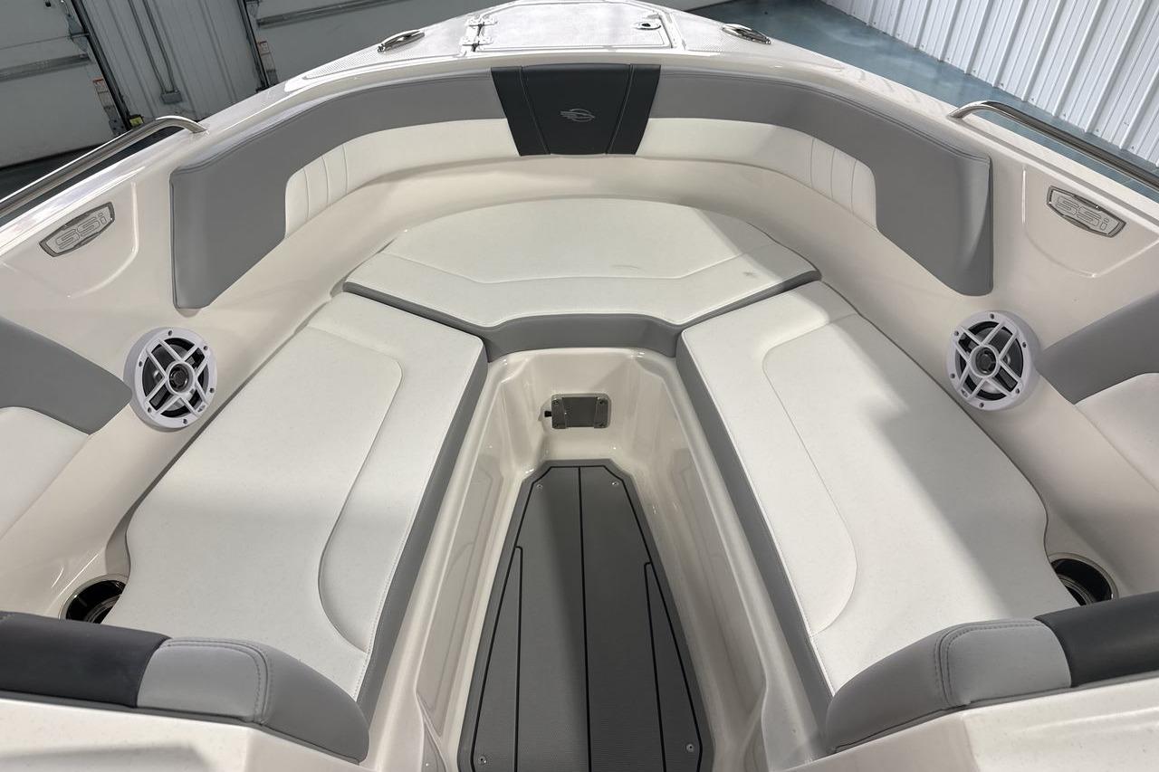 Interior view of a Chaparral 23 SSi boat with gray and white upholstery.