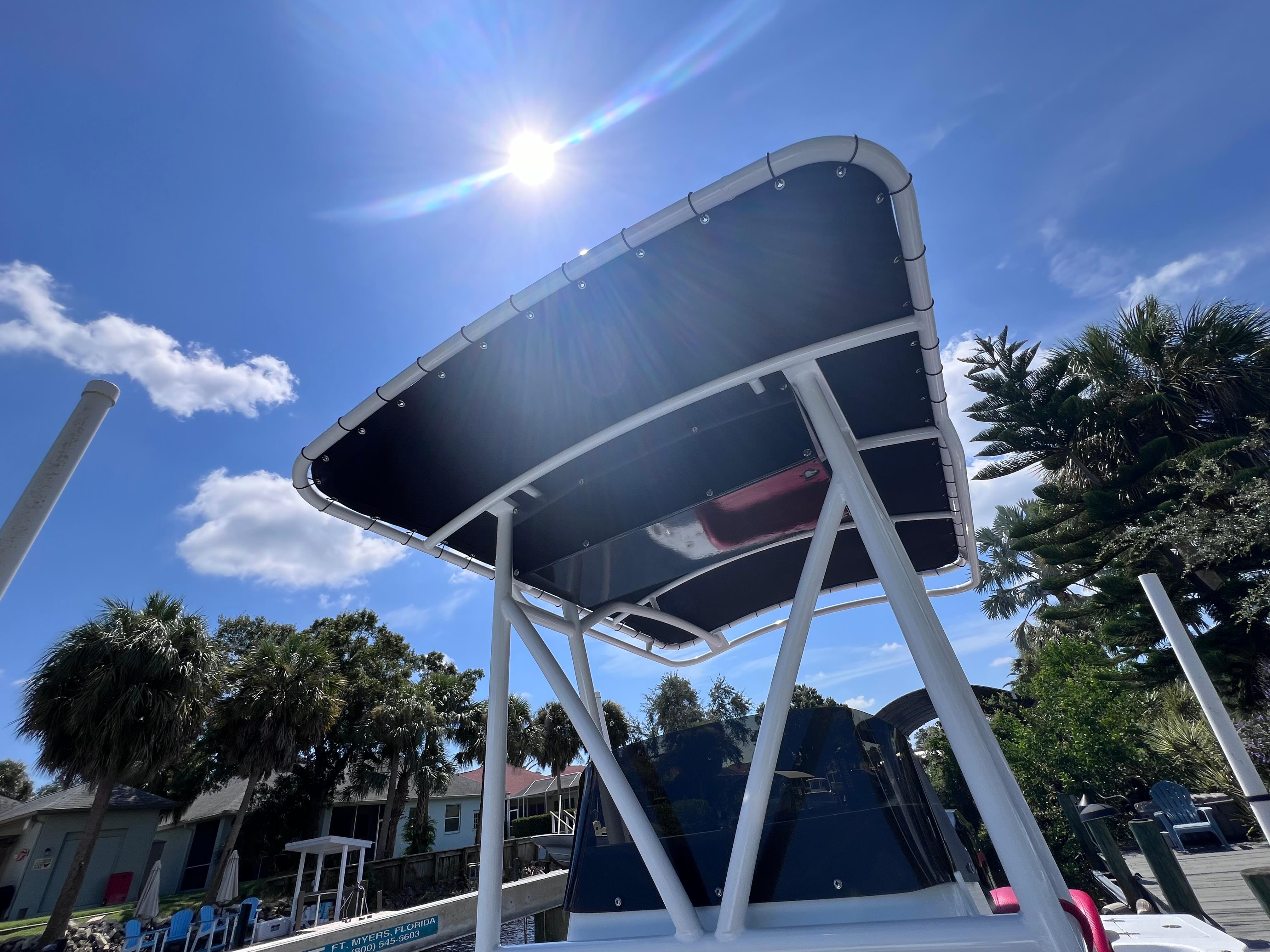 Boat canopy under sunny sky, Concept 23 model, 2000, with palm trees in the background.
