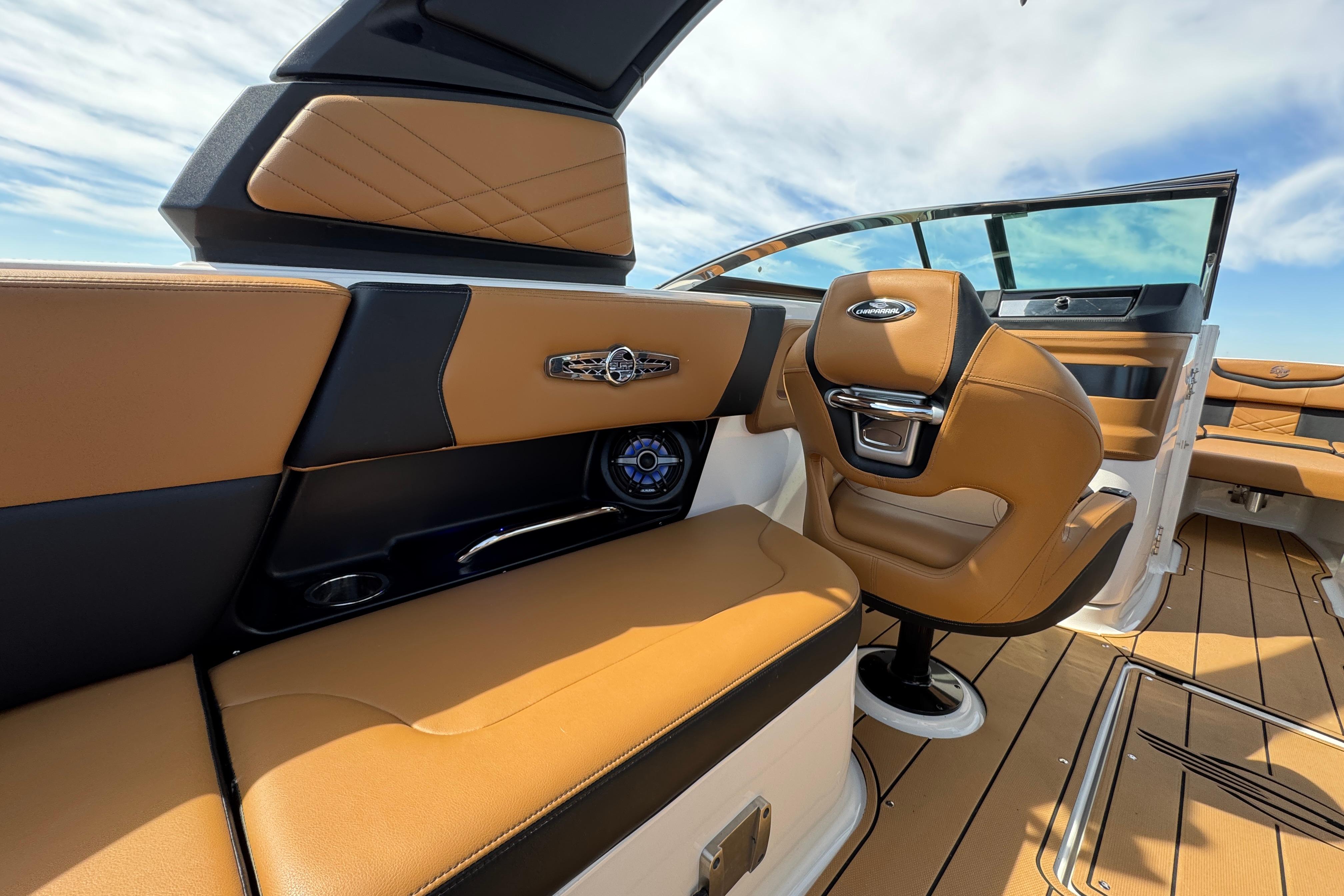Luxurious interior of 2023 Chaparral 26 Surf boat with tan leather seating.