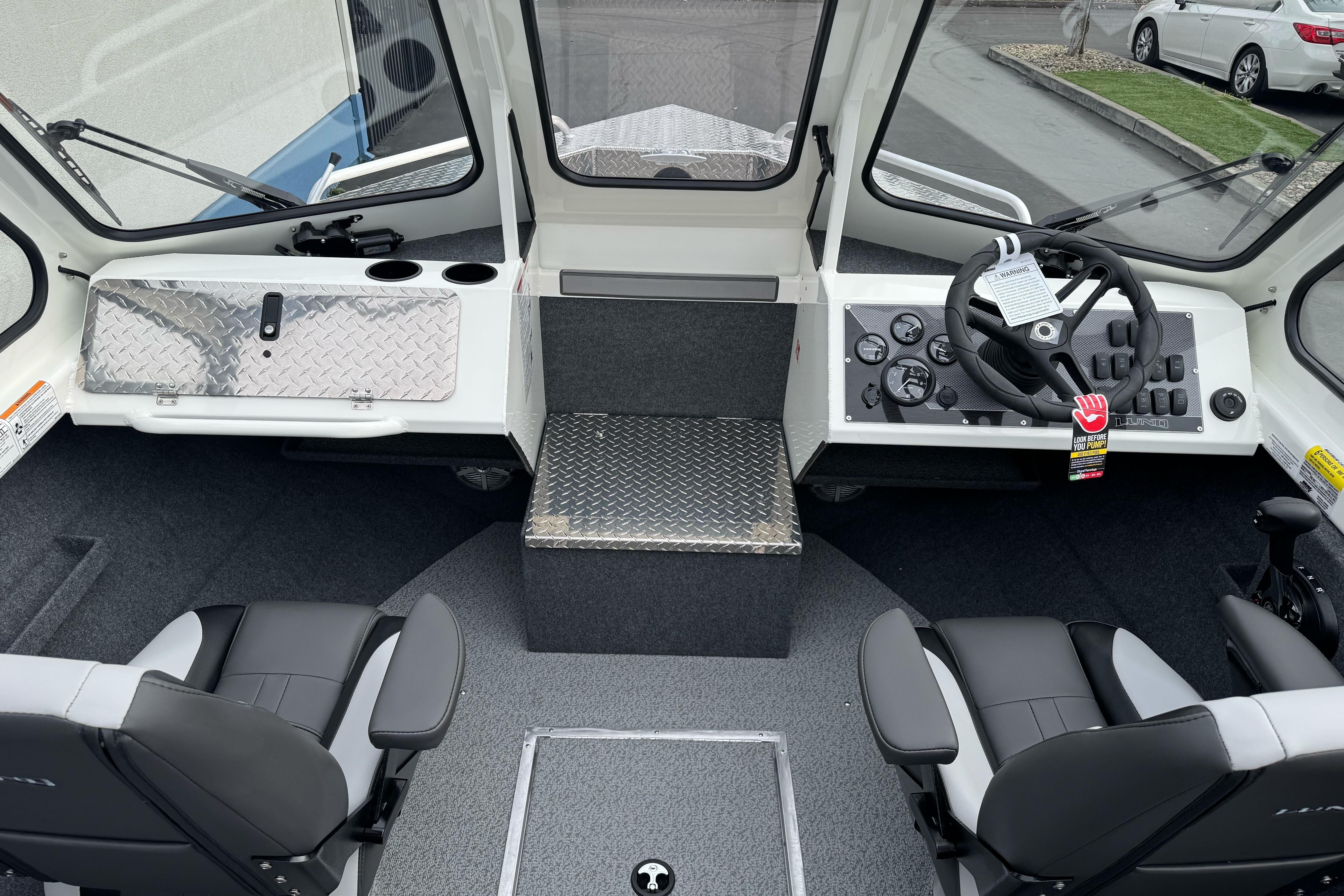 2026 Lund 185 Heavy Gauge boat interior with steering wheel and seating.