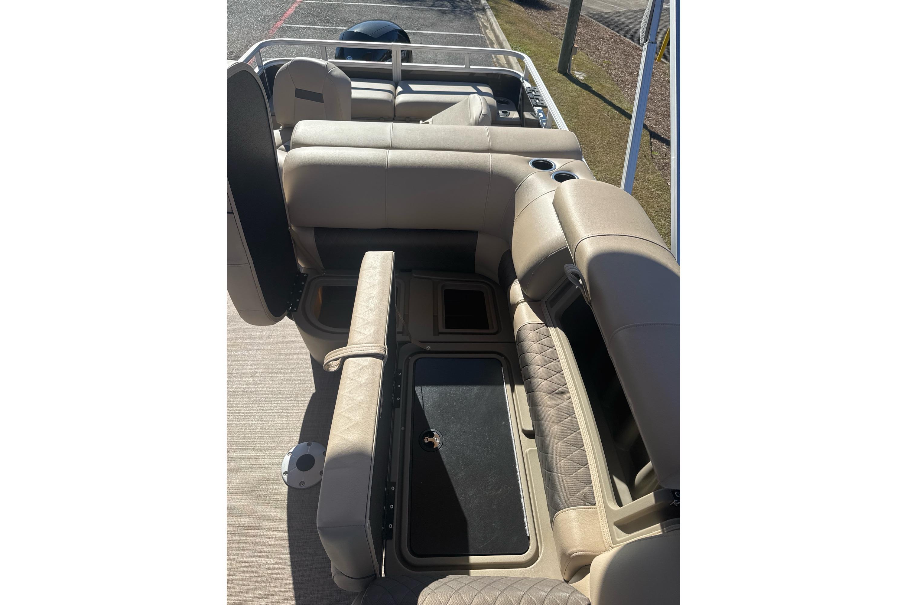 2025 Sun Tracker SportFish 22 DLX boat interior with beige seating and storage compartments.