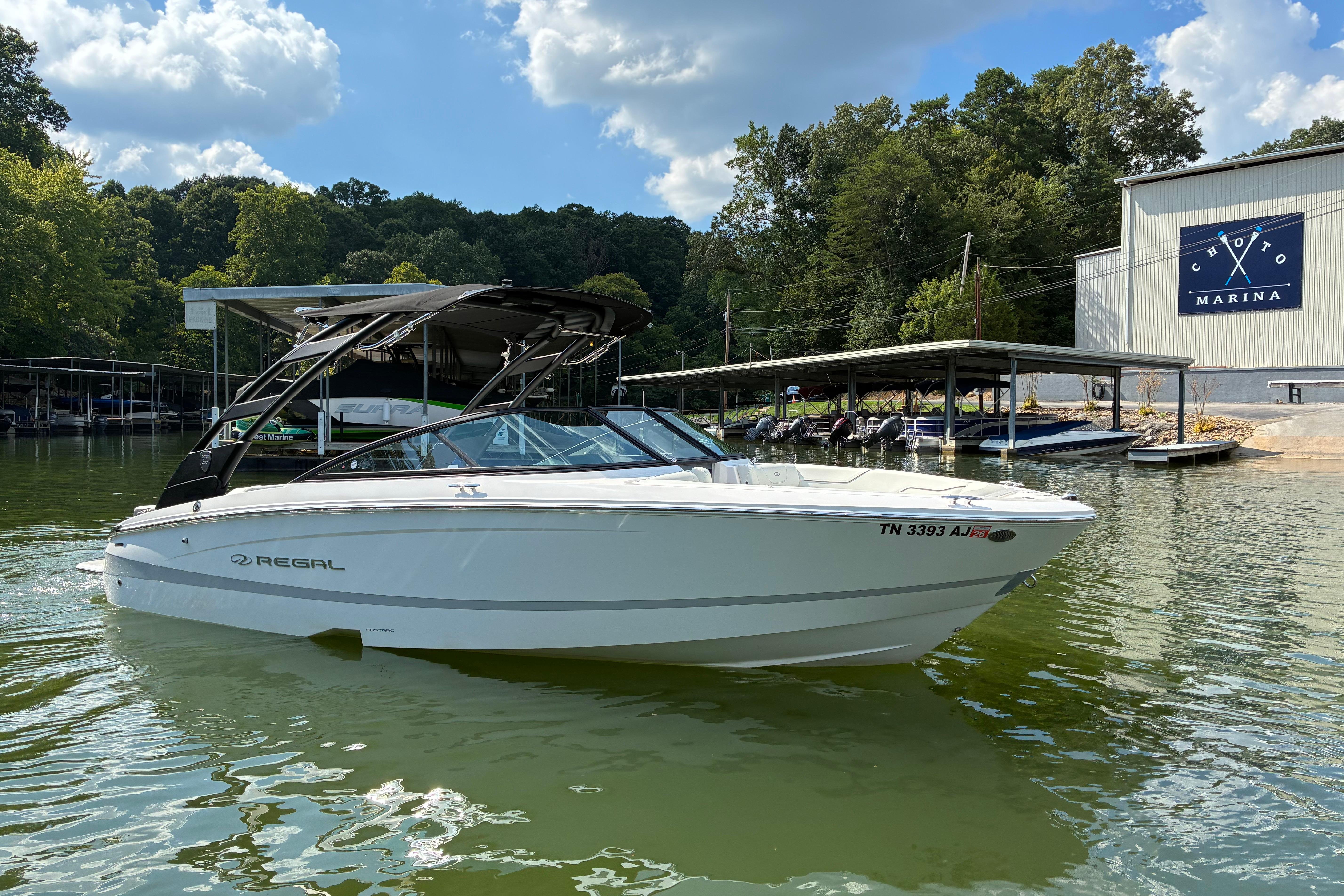 2025 Regal LS2 boat docked at Choto Marina under a sunny sky.