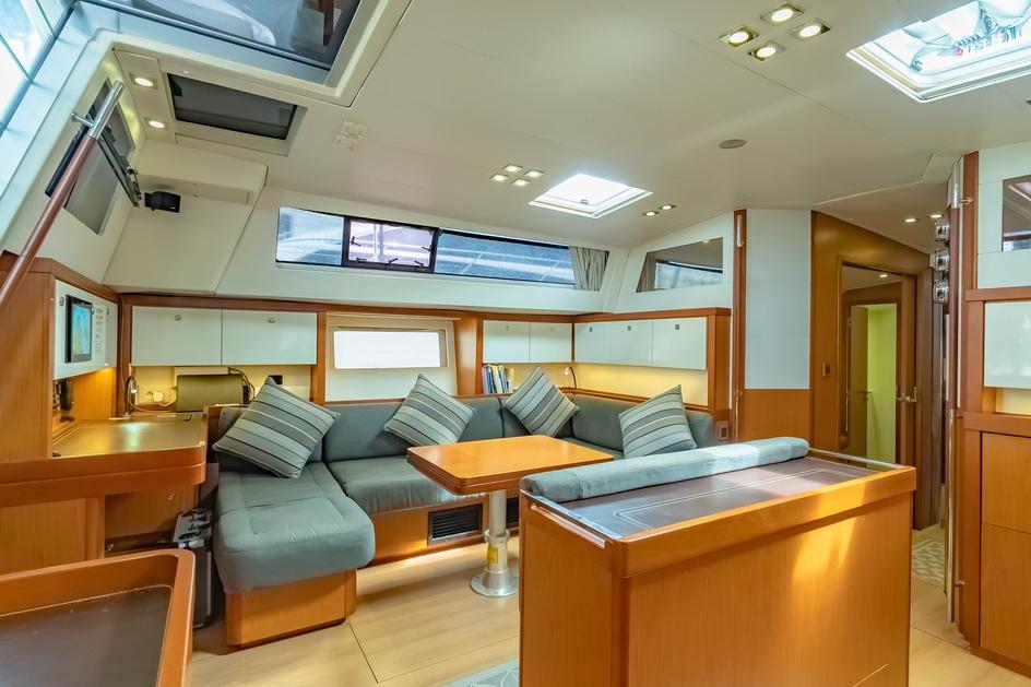 Luxurious interior of 2012 Beneteau Sense 55 yacht with modern seating and skylights.