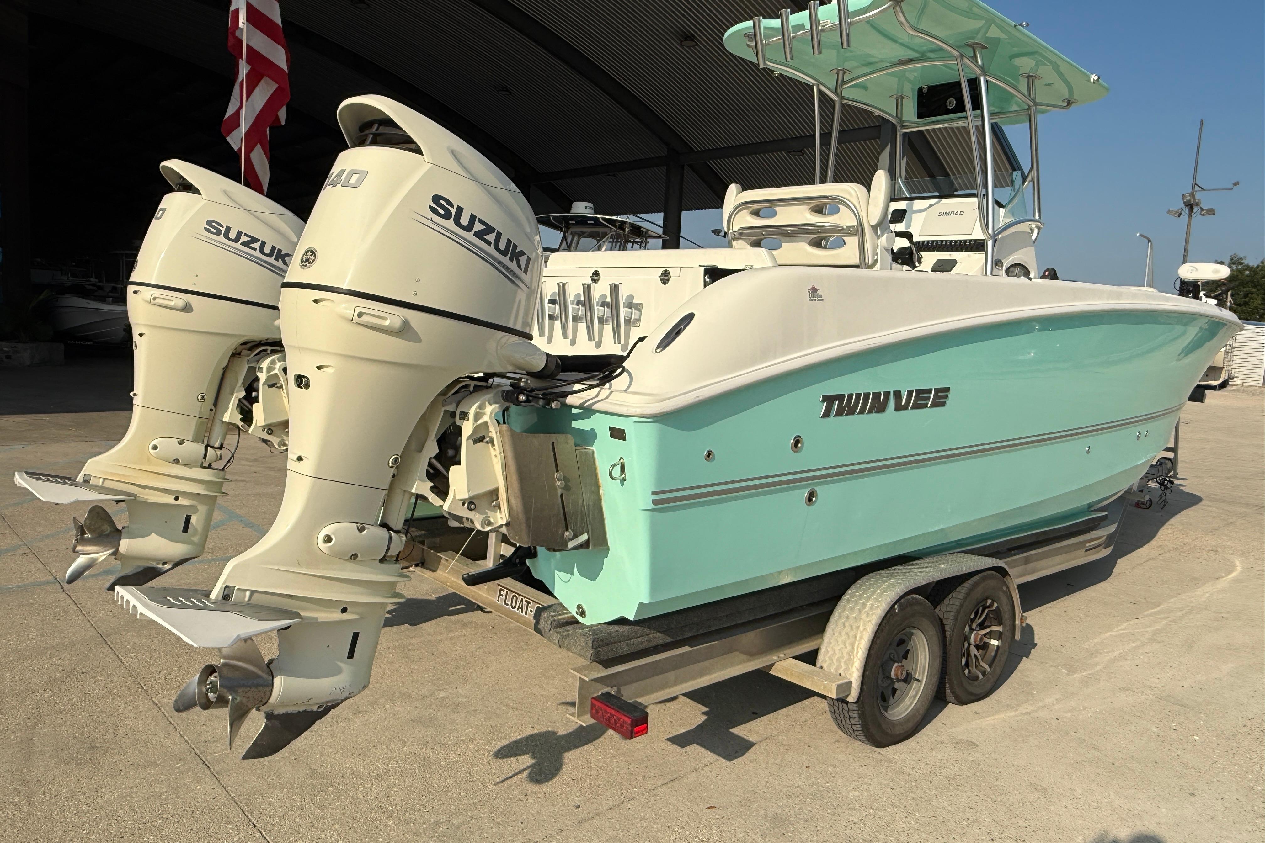 2020 Twin Vee 240 GFX CC boat with dual Suzuki outboard engines on a trailer.