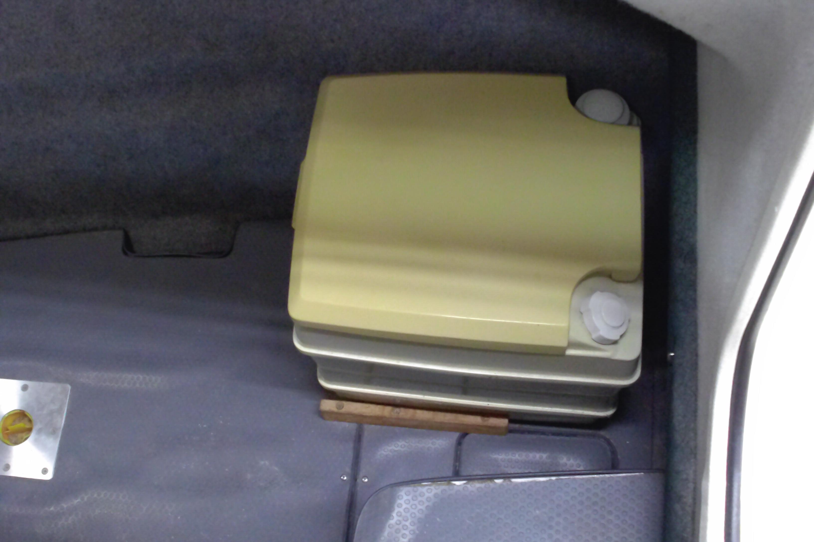 Portable toilet in 2004 Trophy 2352 Walkaround boat cabin interior.
