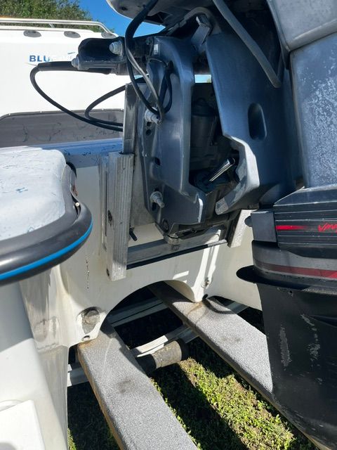 Close-up of a boat's stern with motor and trailer.