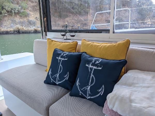 Cozy boat interior with anchor-themed pillows on a Bali 4.8, 2021 model.