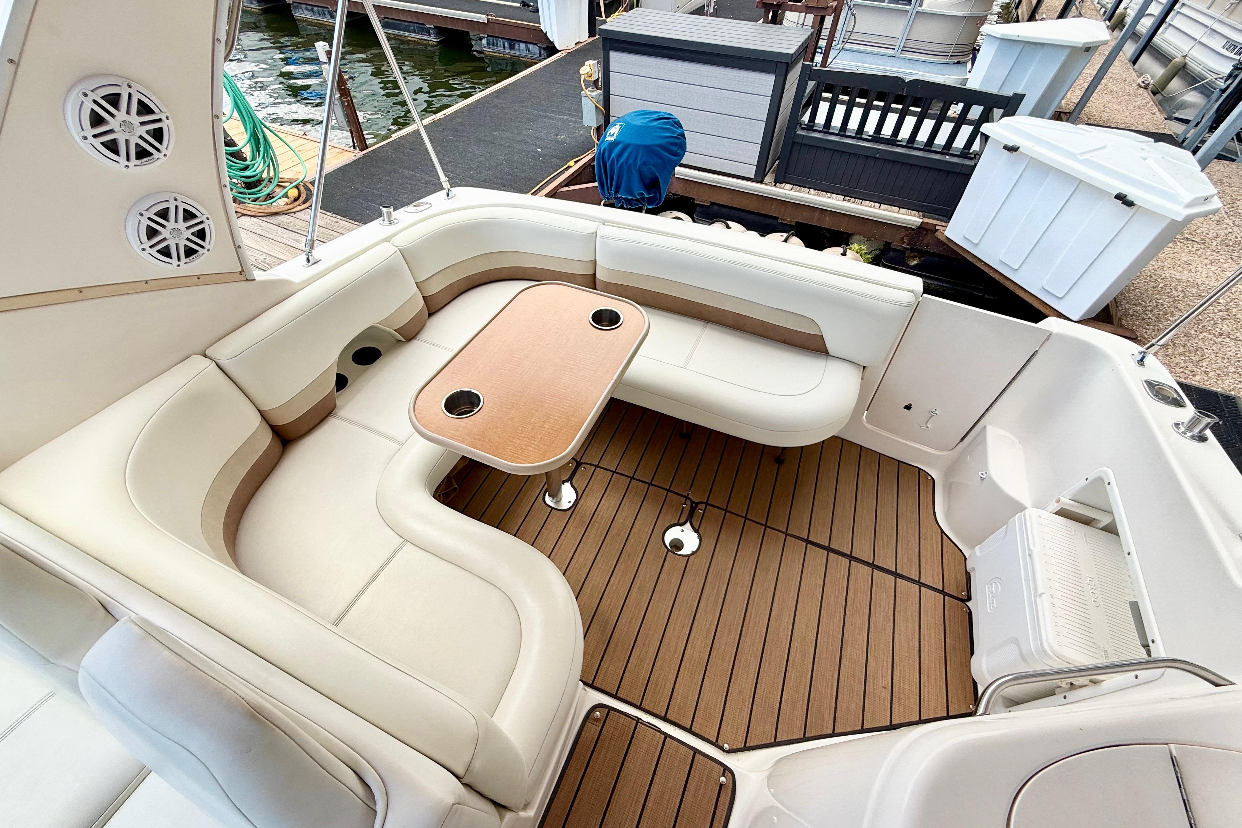 1999 Chaparral Signature 300 boat interior with cushioned seating and wooden table.