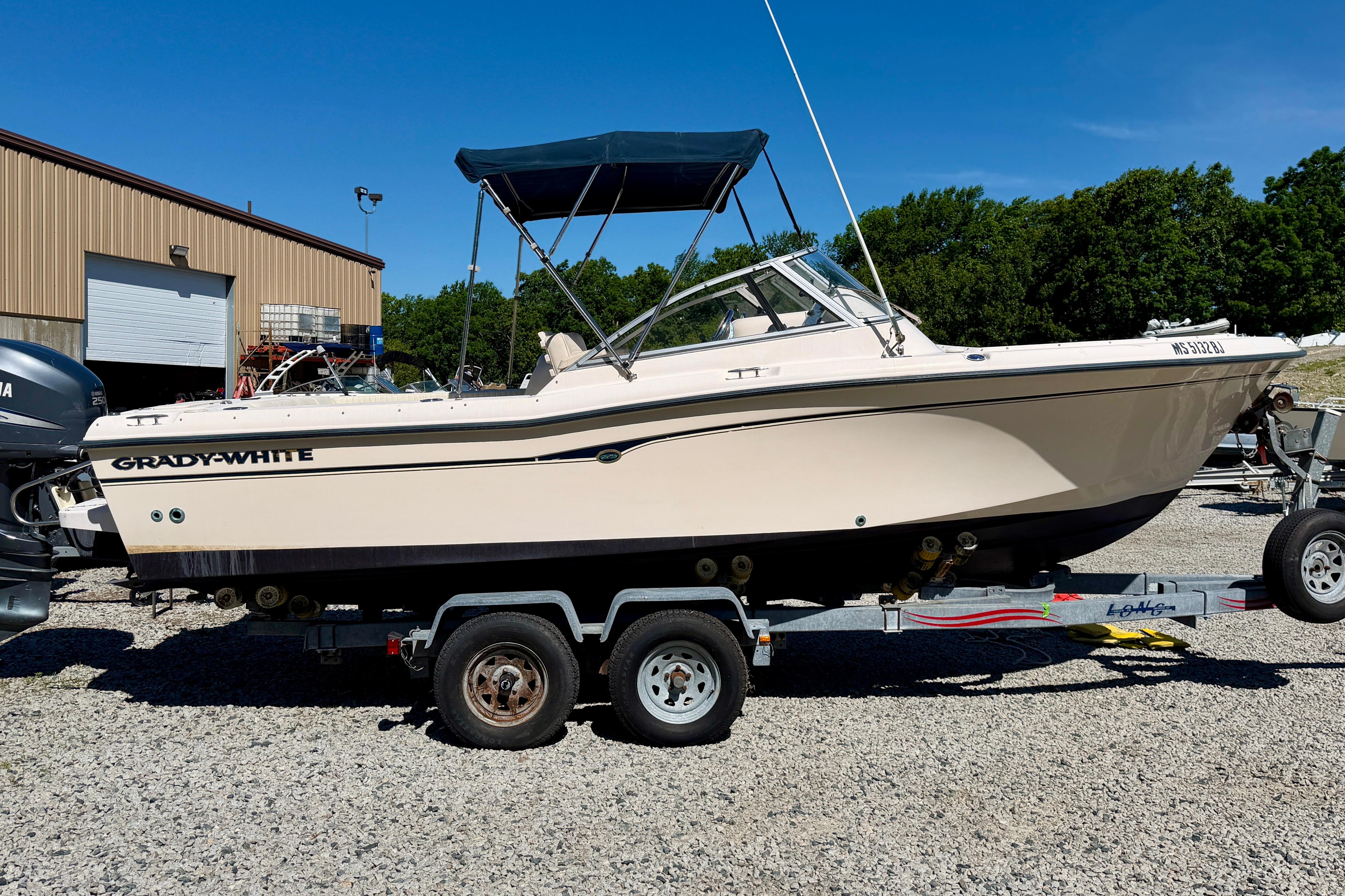 2005 Grady-White Freedom 225 boat on trailer, parked outdoors.