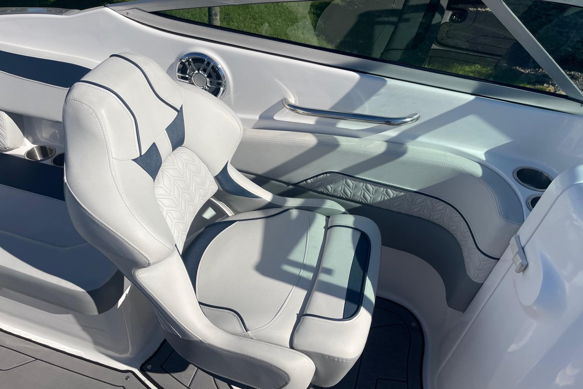 2023 Hurricane SunDeck 2400 OB boat interior with white seating and modern design.