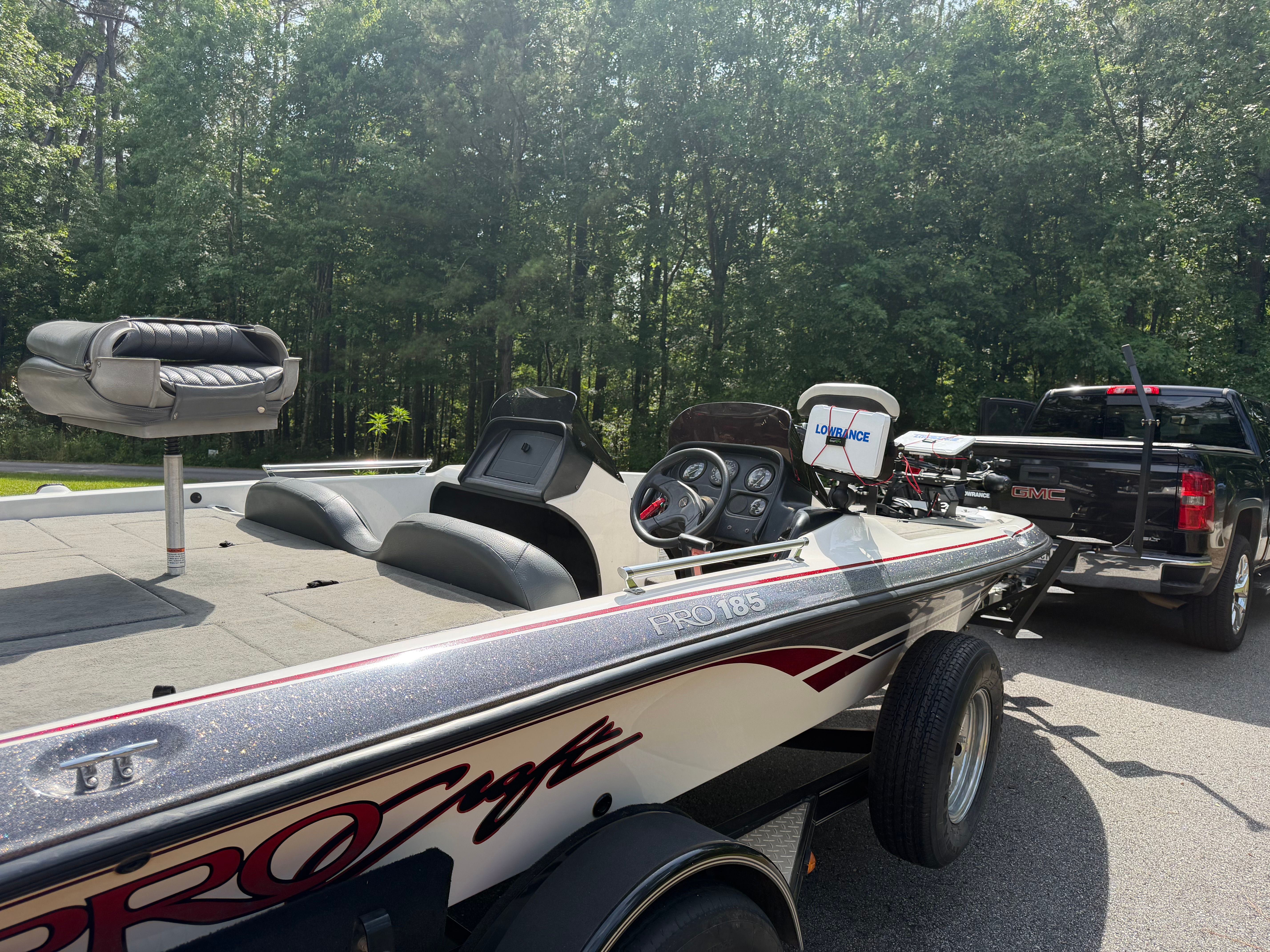 A 2001 ProCraft Pro 185 SC/DC boat on a trailer, towed by a black pickup truck.