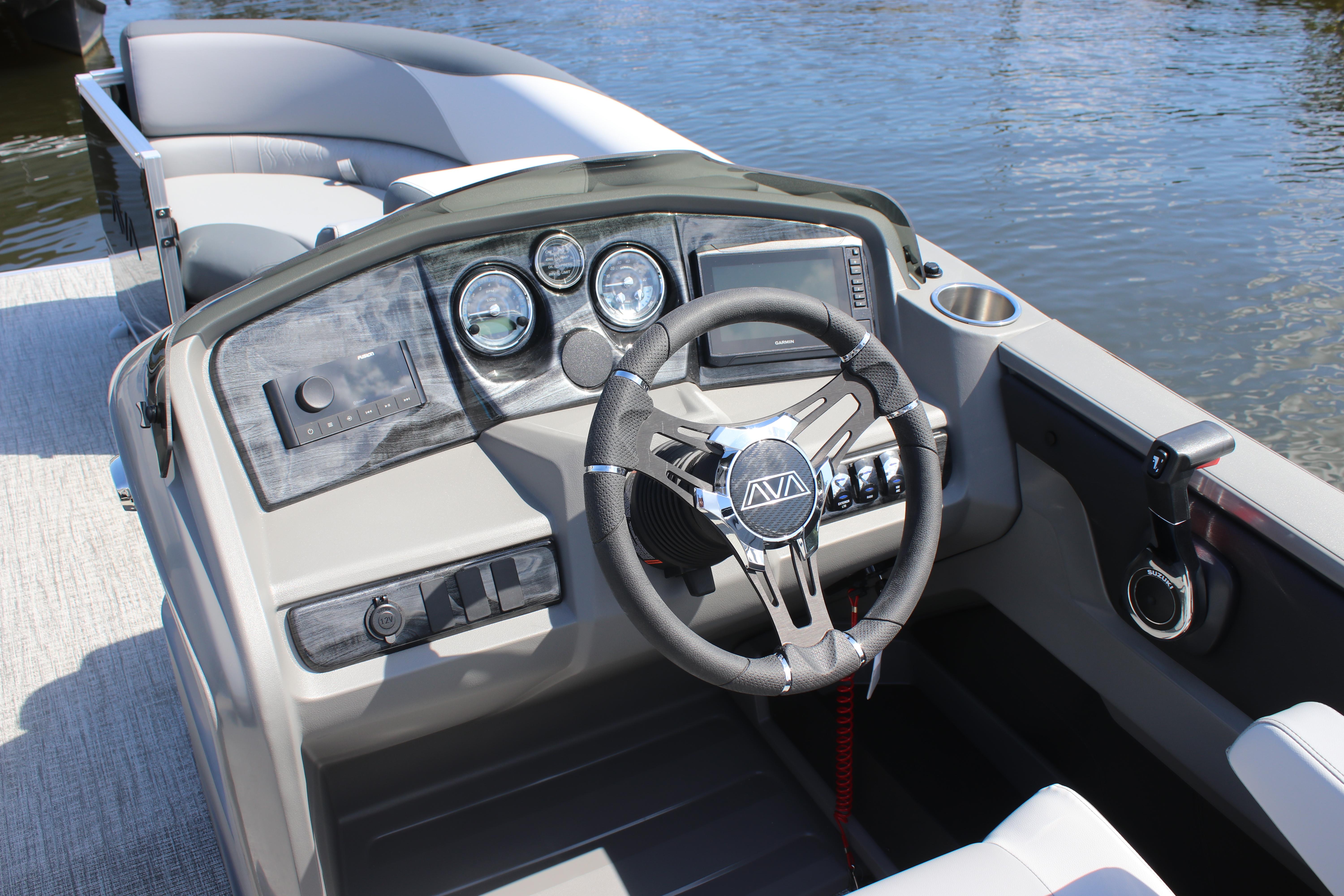 2025 Avalon LSZ Quad Lounger boat dashboard with steering wheel and controls.