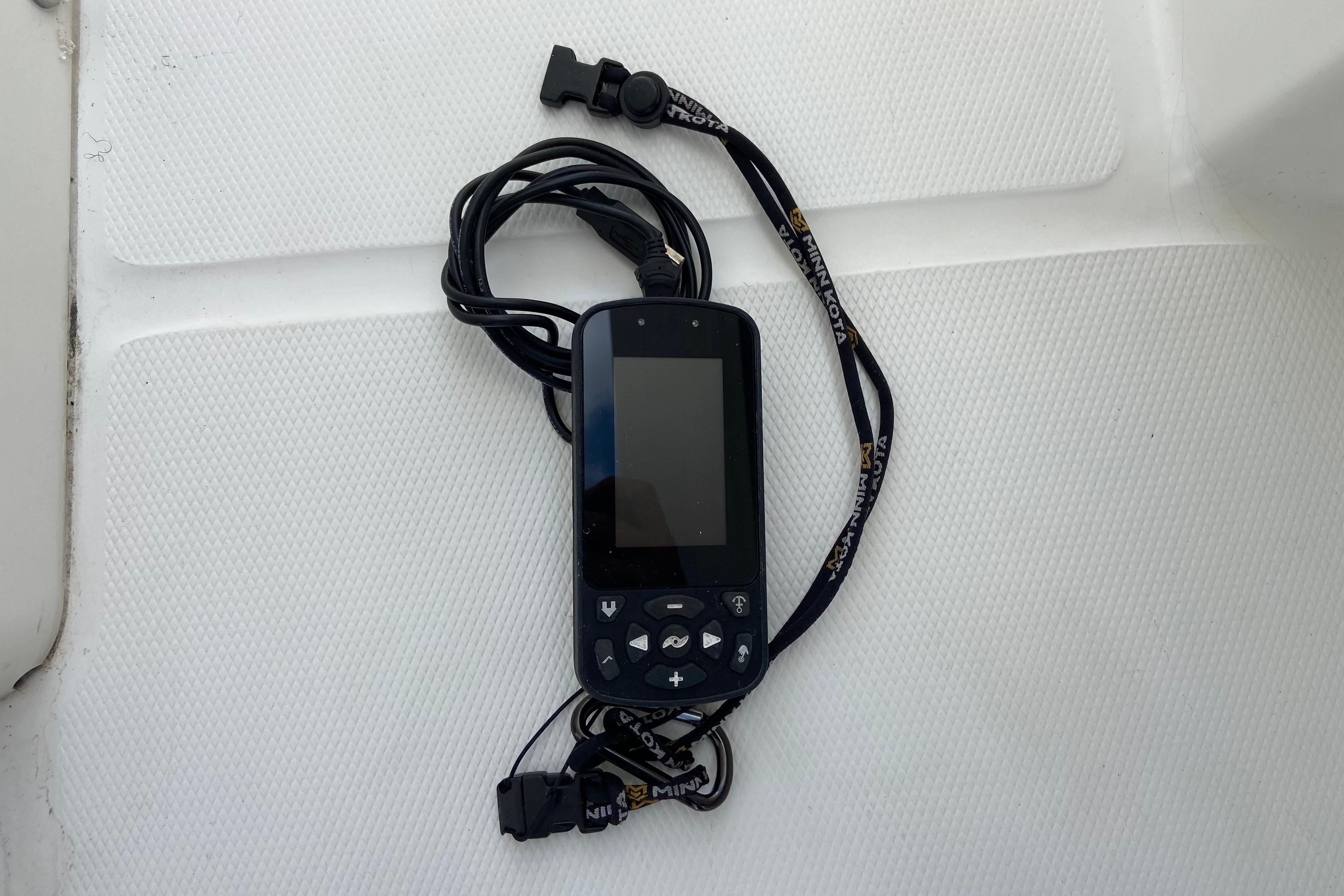 Handheld device with buttons and lanyard on Regulator 28 boat, 2021 model.