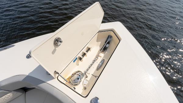 2025 Scout 425 LXF boat anchor compartment open on calm water.