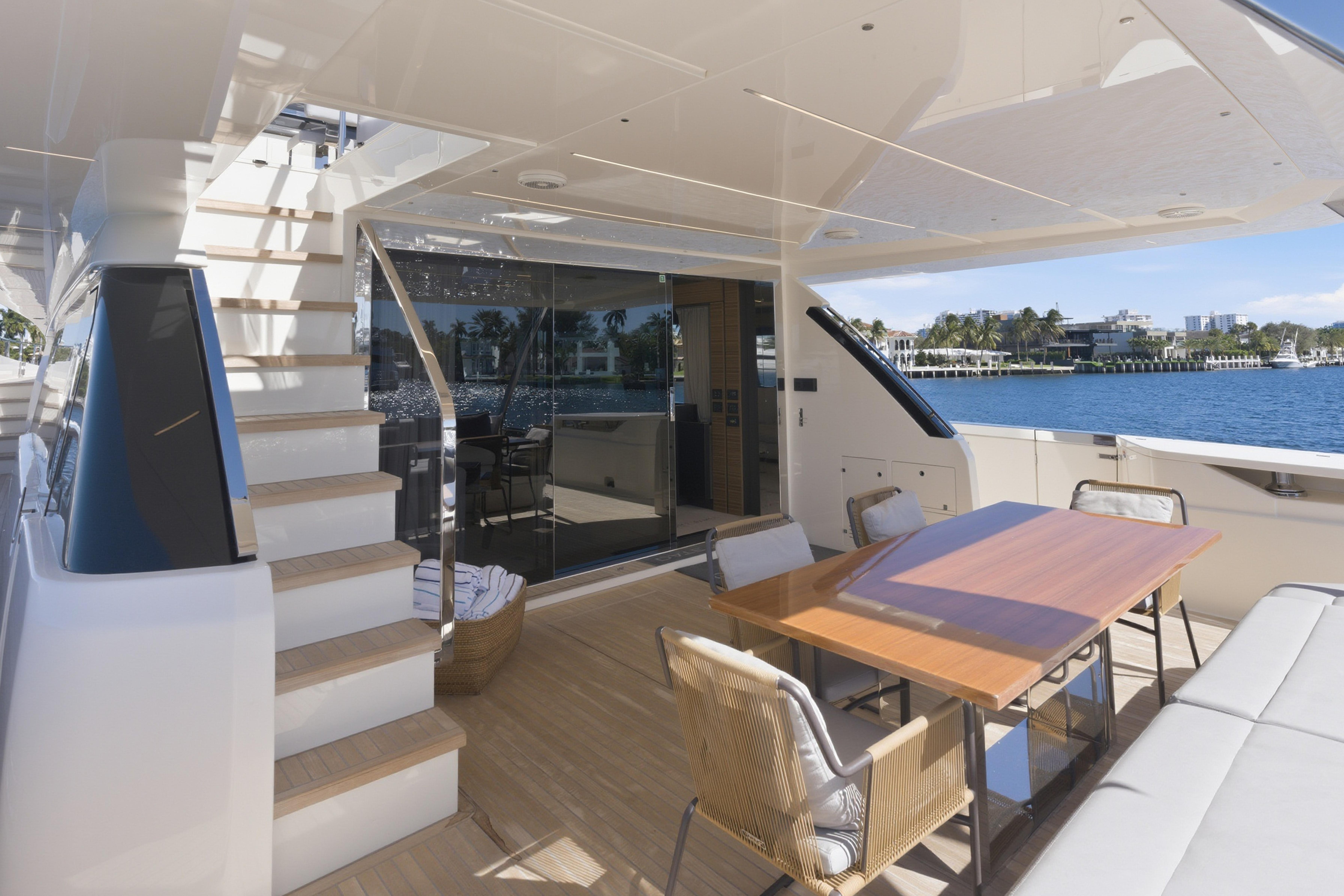 Luxurious 2018 Ferretti Yachts 920 deck with elegant seating and scenic waterfront view.