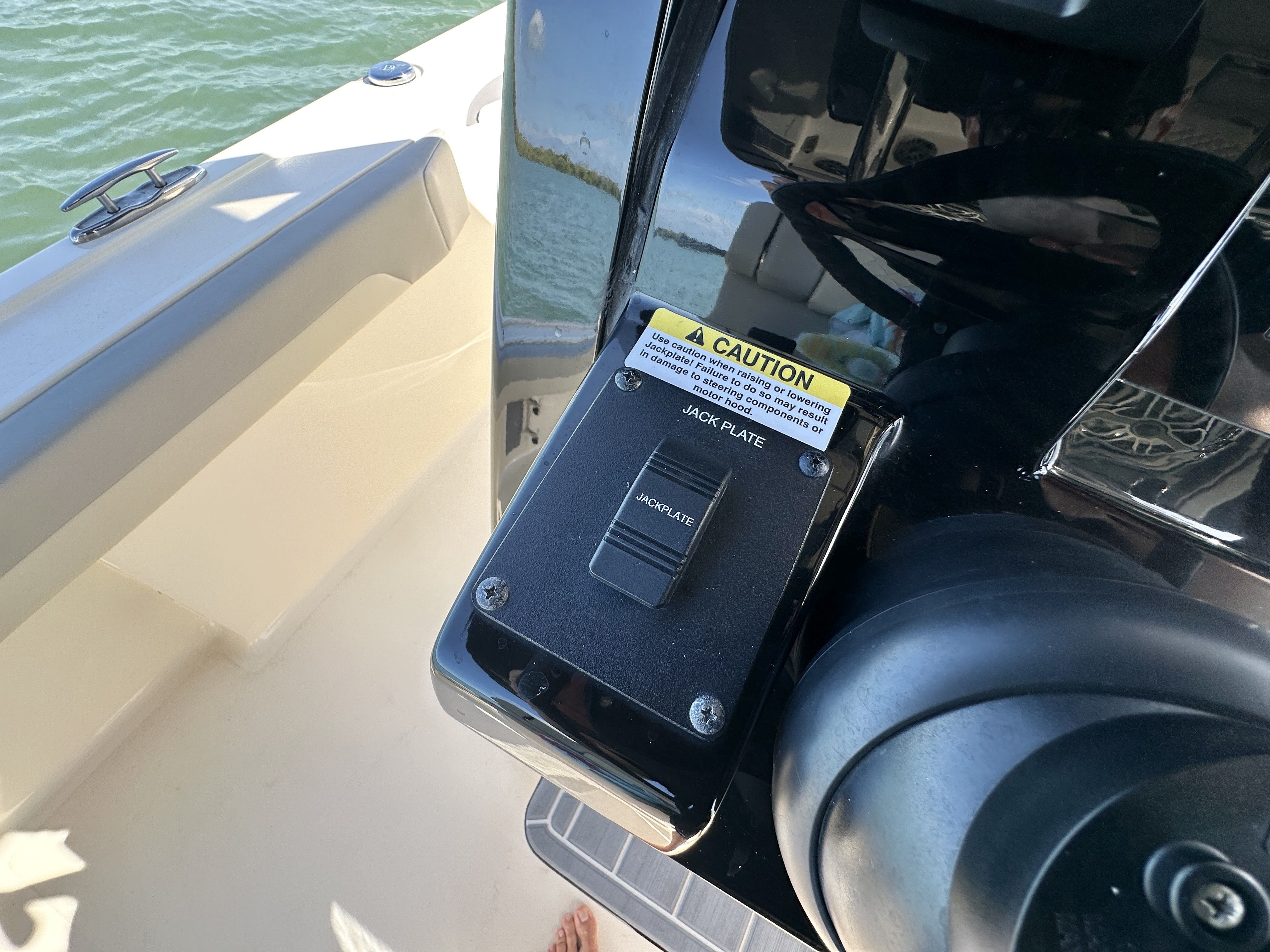 Close-up of a control panel on a boat, surrounded by water.
