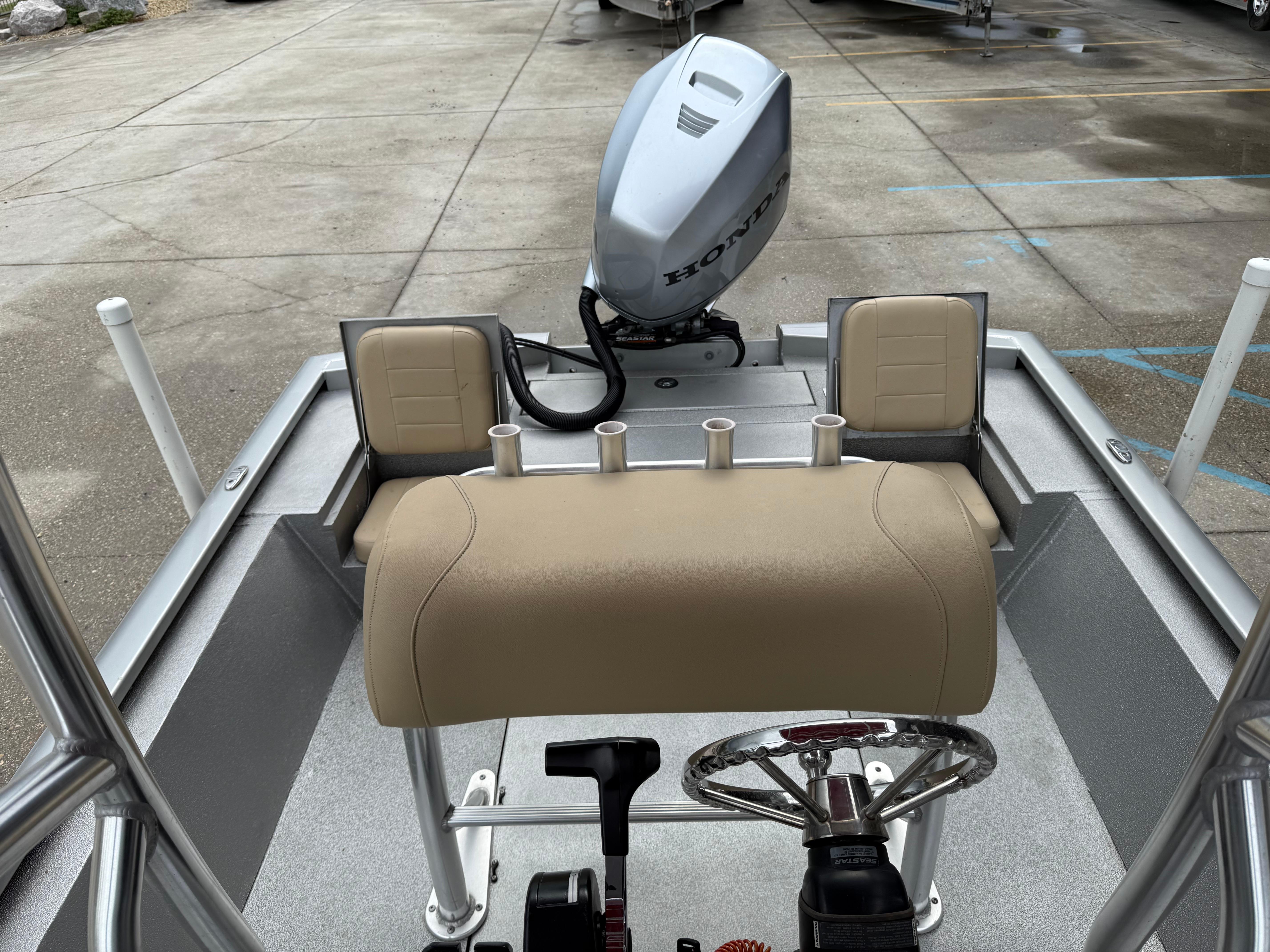 2020 Avid 23 FS Platinum boat interior with Honda motor, beige seating, and rod holders.