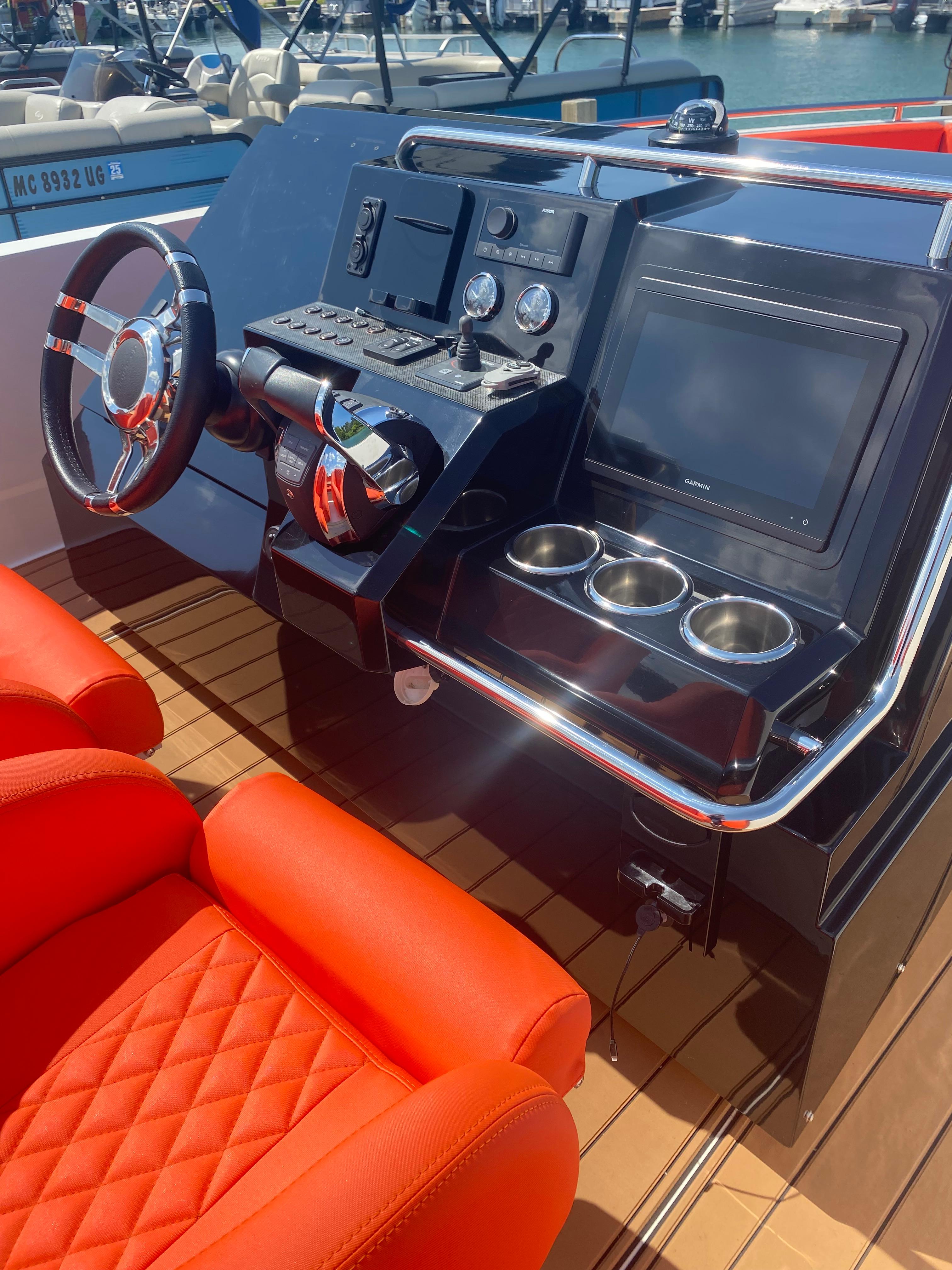 Control panel of 2020 De Antonio Yachts D 28 with red seating and modern dashboard.