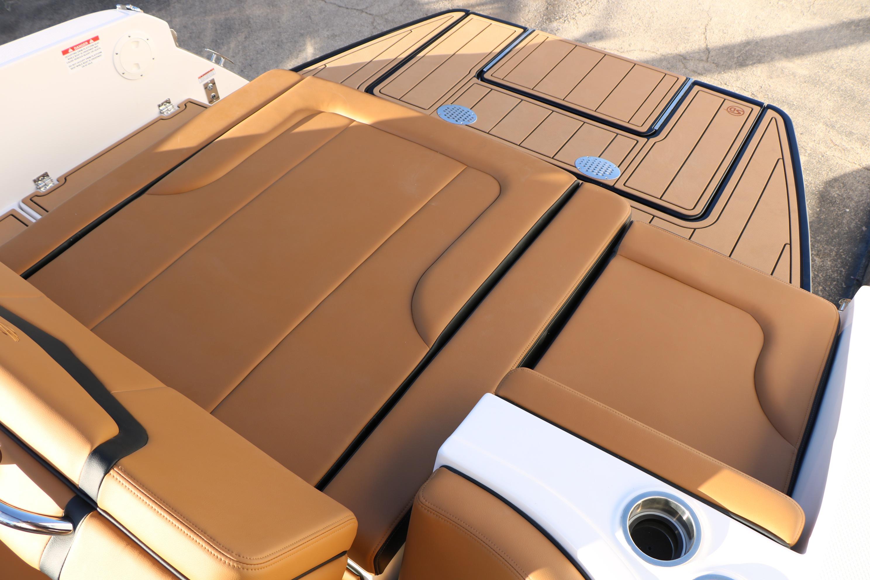 2026 Chaparral 247 SSX boat with tan leather seating and sleek deck design.