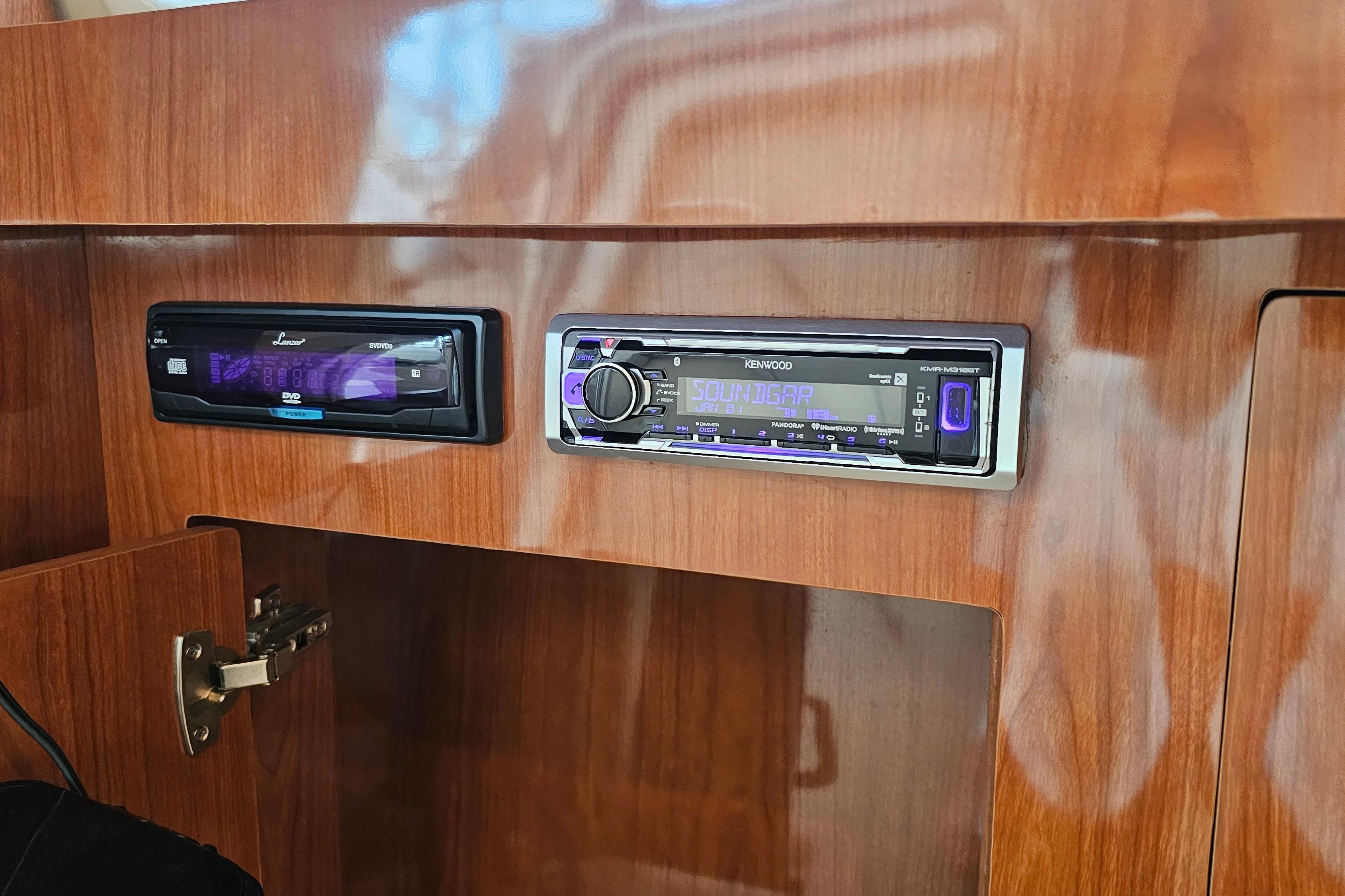 2005 Regal 3060 Window Express interior with Kenwood stereo system and wooden cabinetry.