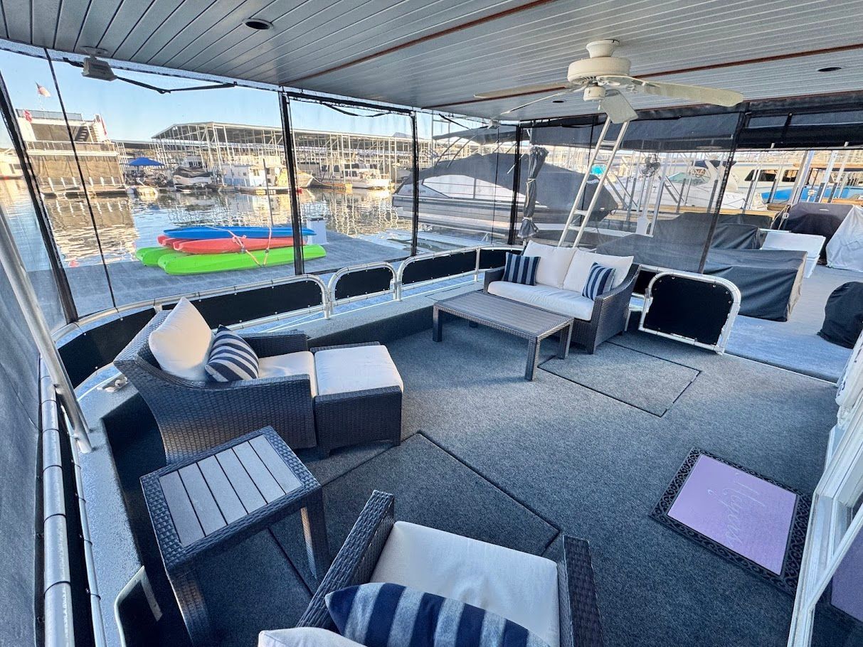 Spacious deck of a 2006 Summersun Houseboats 16x68 with comfortable seating.