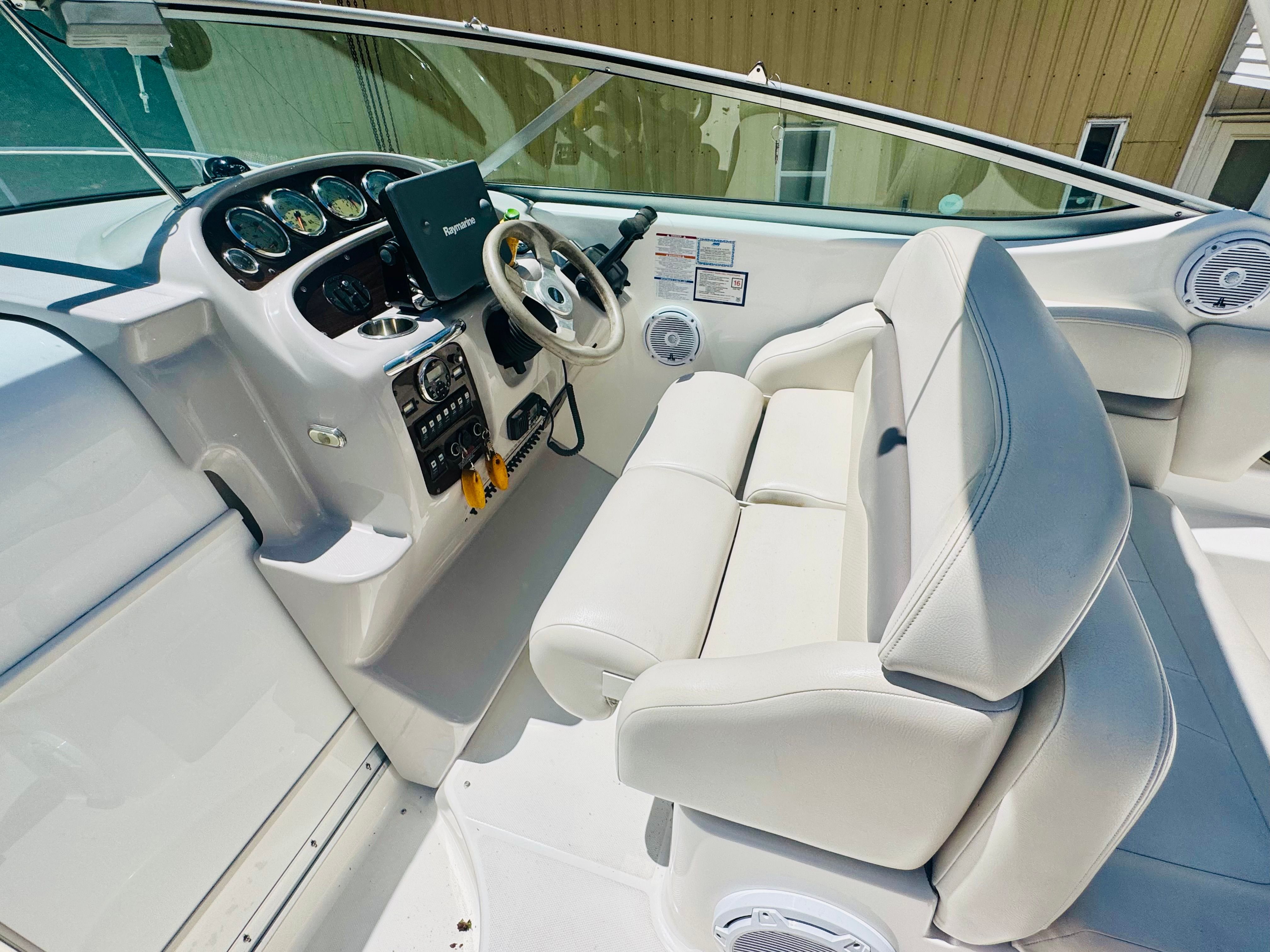 Interior of a 2005 Chaparral Signature 270 boat with helm console.