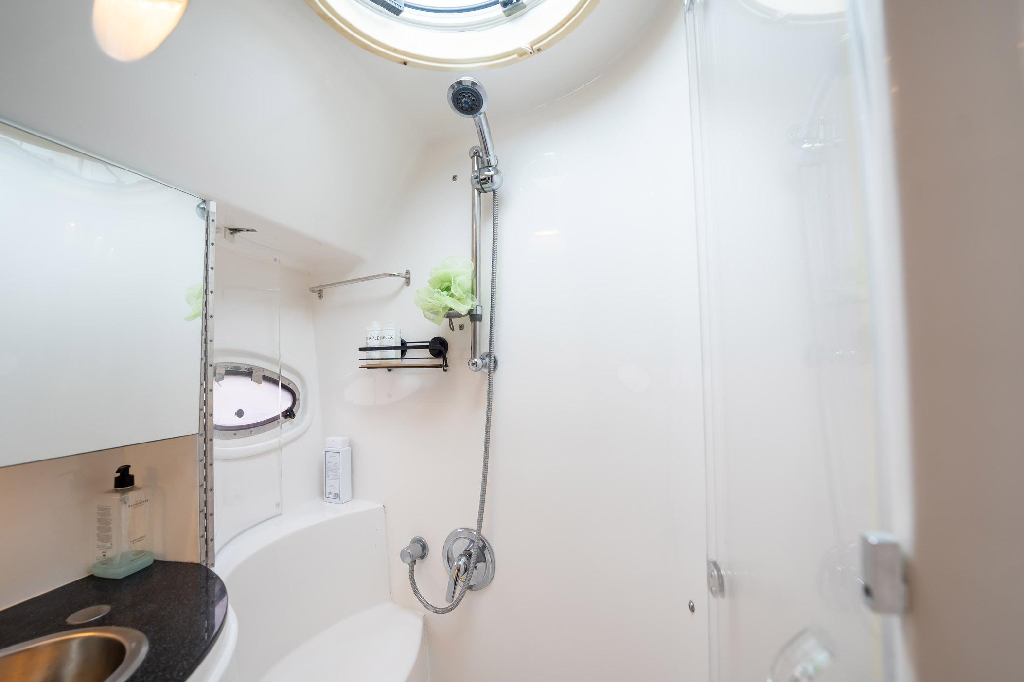 Bathroom interior of 2008 Regal Commodore 4460 yacht, featuring shower and sink.