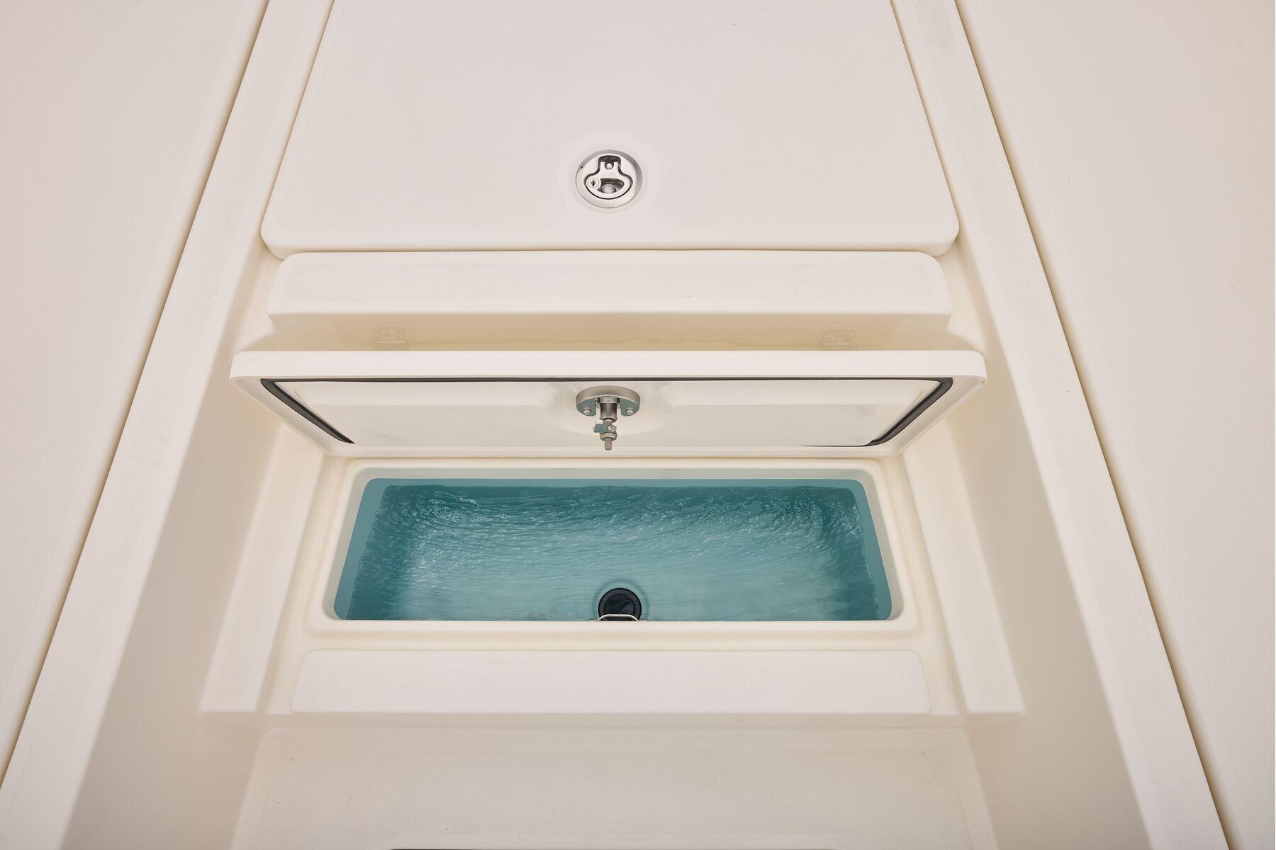 Livewell compartment on 2026 Mako 24 APEX boat, featuring a sleek design.